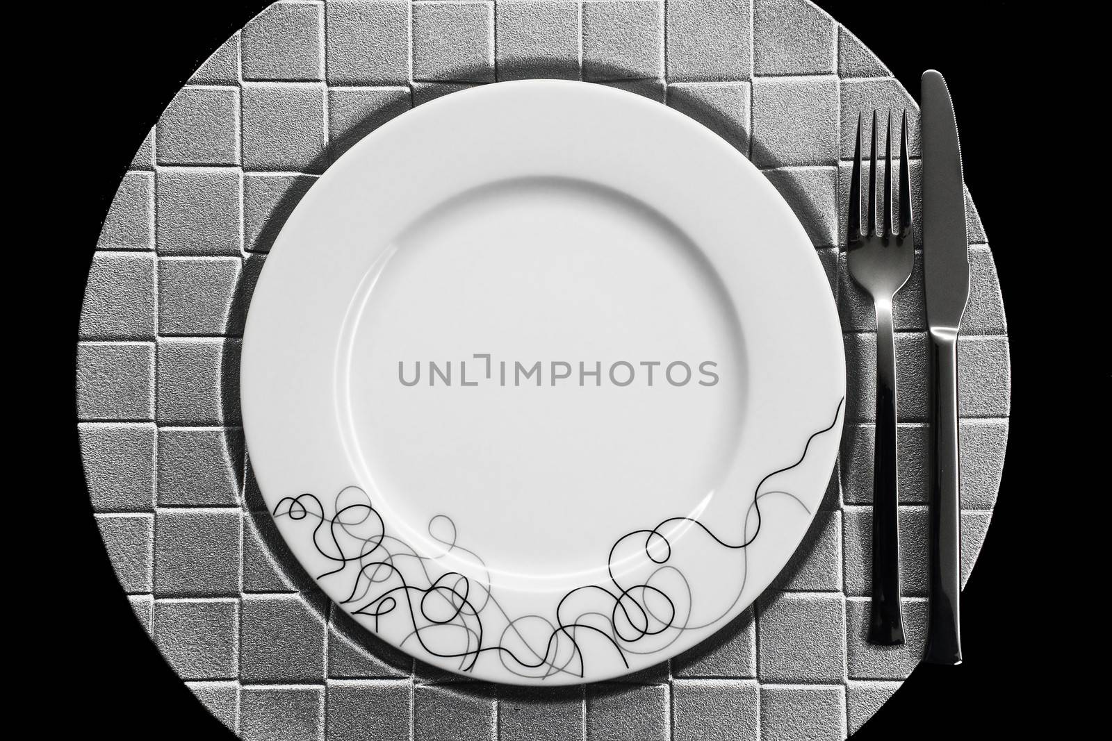 Cutlery and dish on black background