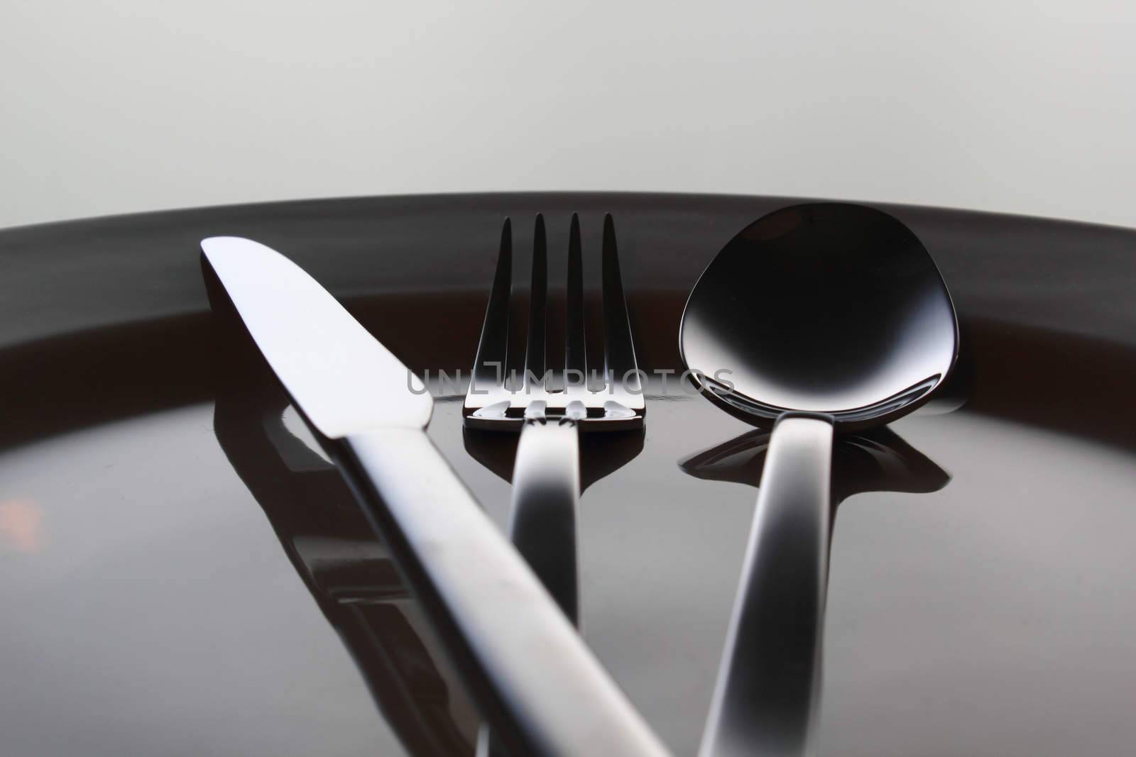 Silver Fork, knife and spoon on a dish