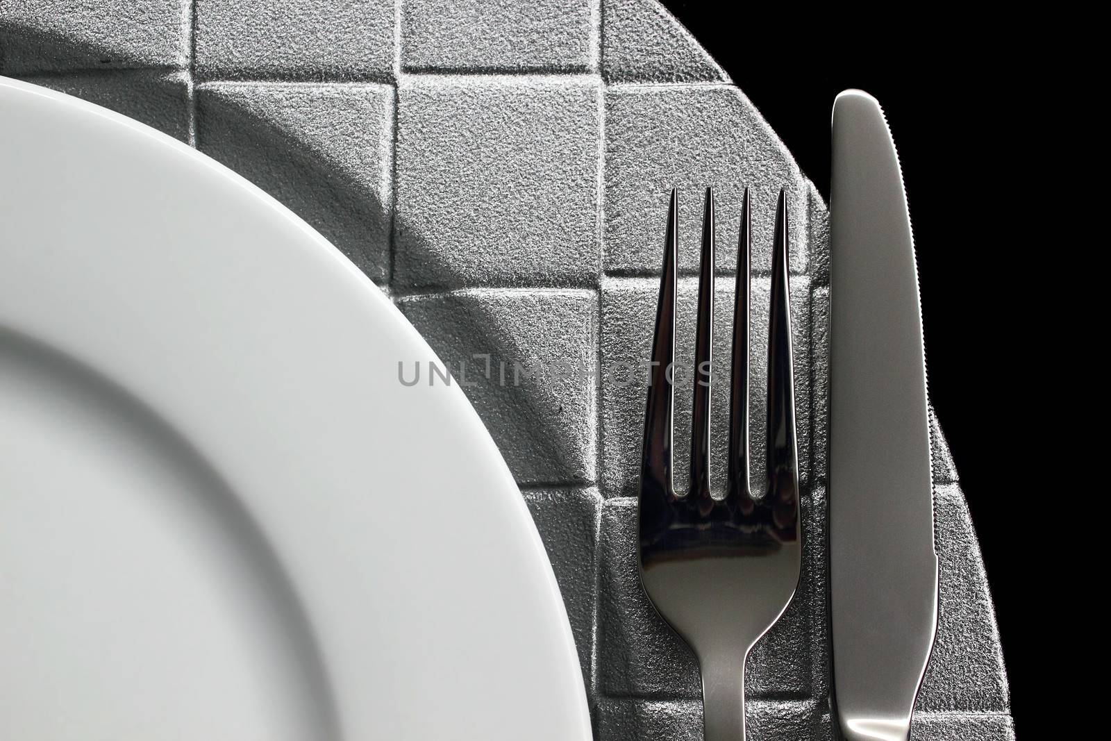 Cutlery and dish on black background