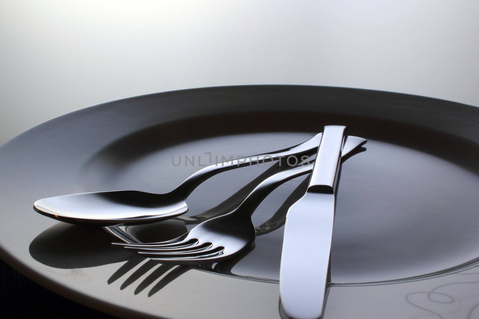 Silver Fork, knife and spoon on a dish