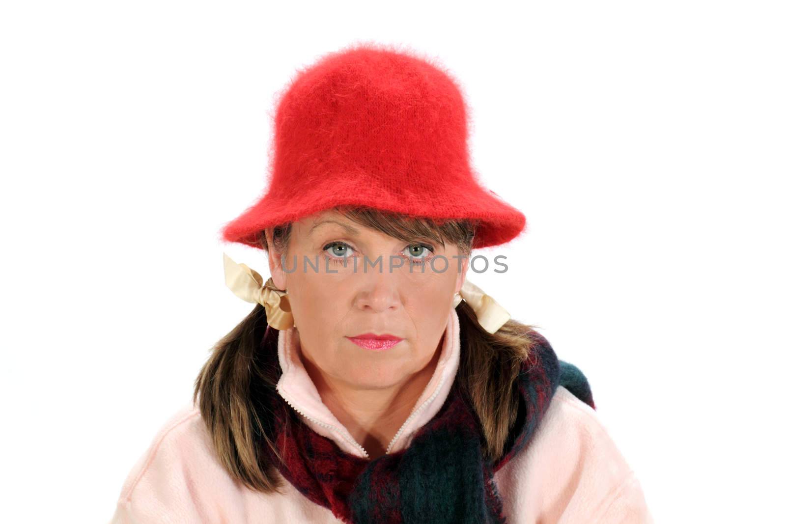 Pensive middle aged woman with scarf and wooly hat.