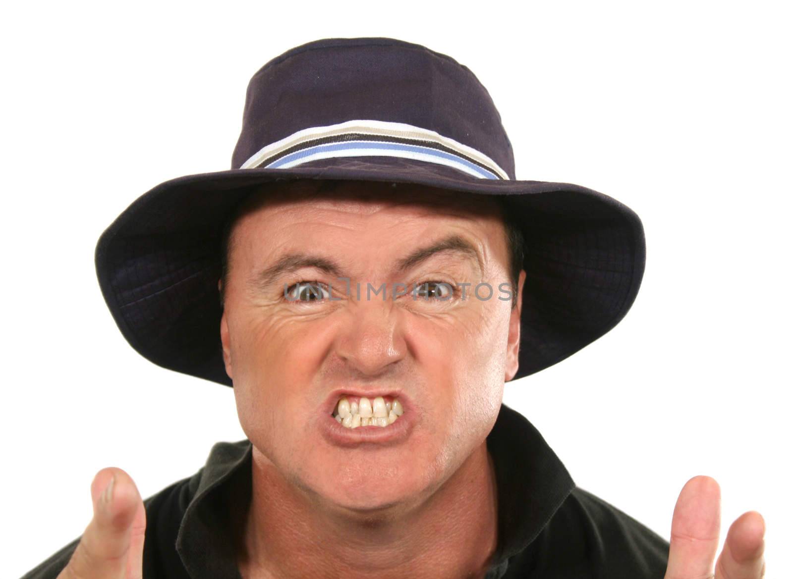 Angry middle aged man in a blue hat pointing.