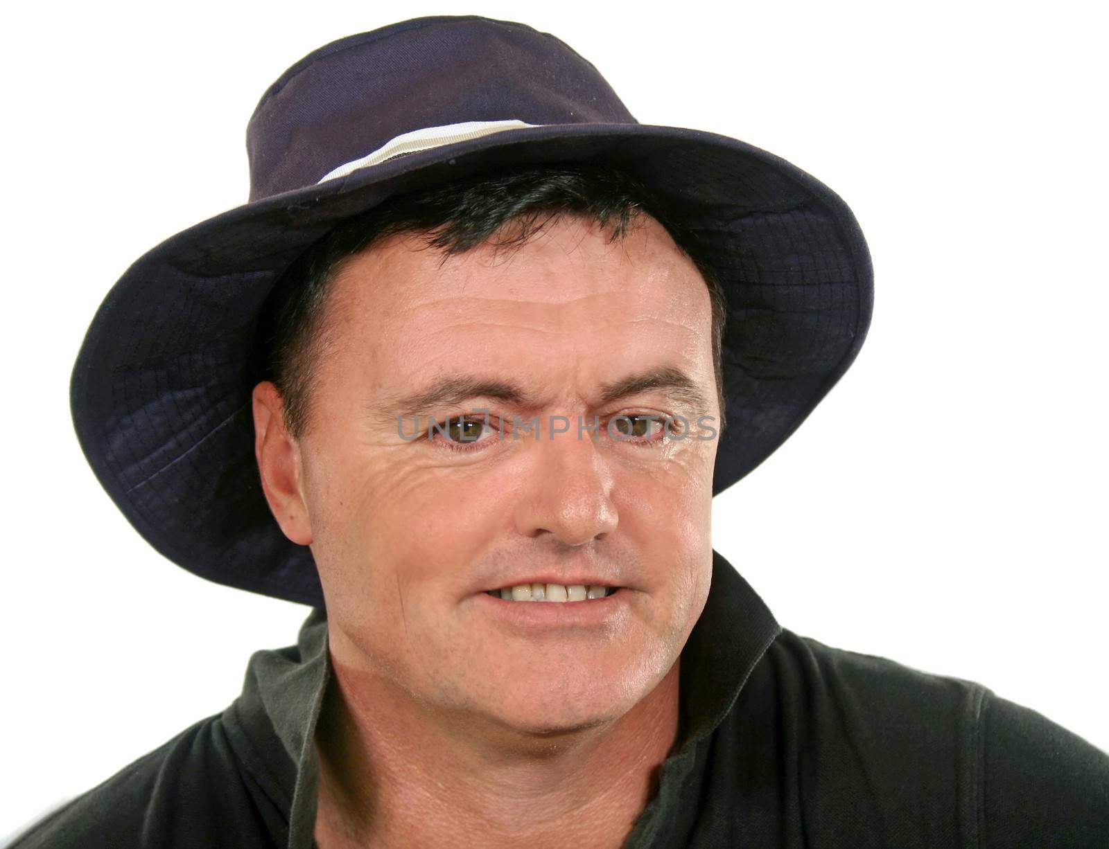 Close up of smiling middle aged man in a hat.