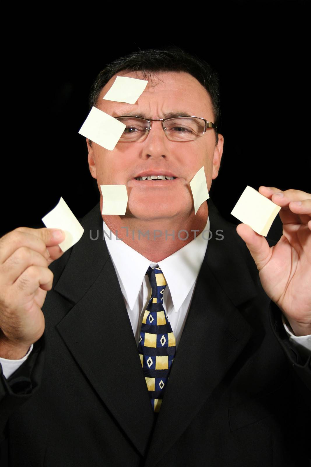 Busy salesman confused with his Post-it Notes.