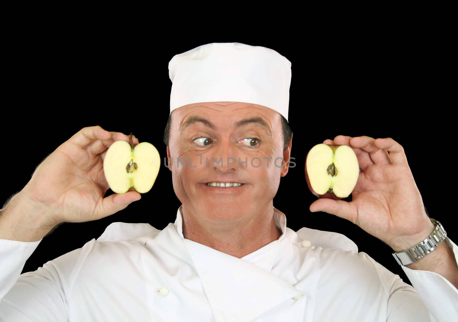Chef holds two halves of a cut apple.