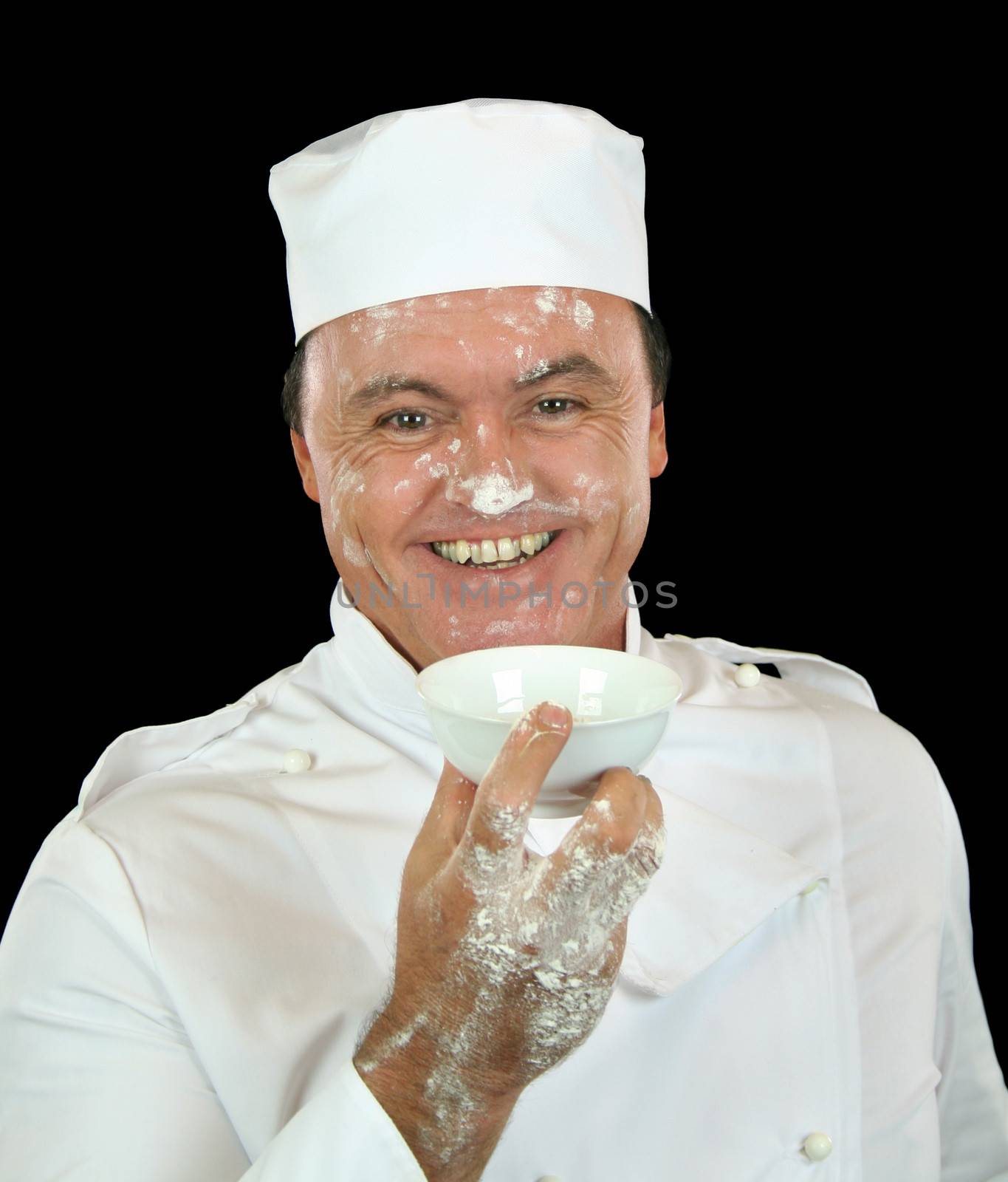 Smiling chef has had a nasty accident with the flour.