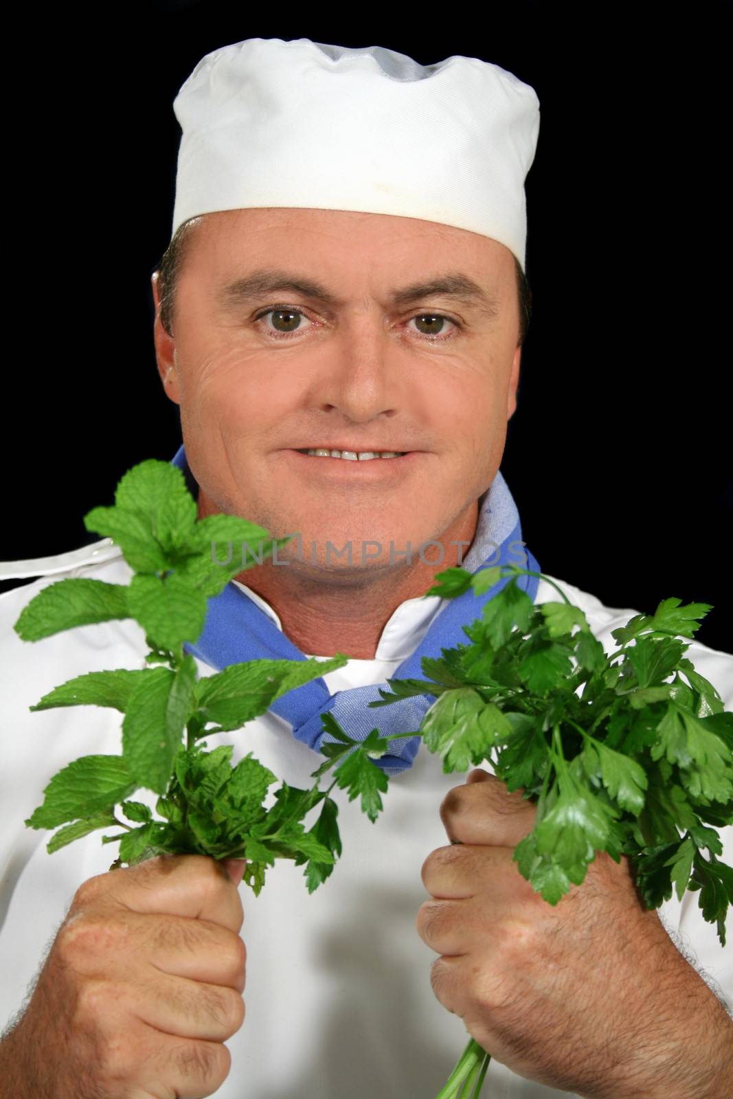 Chef with his fresh herbs ready to prepare.