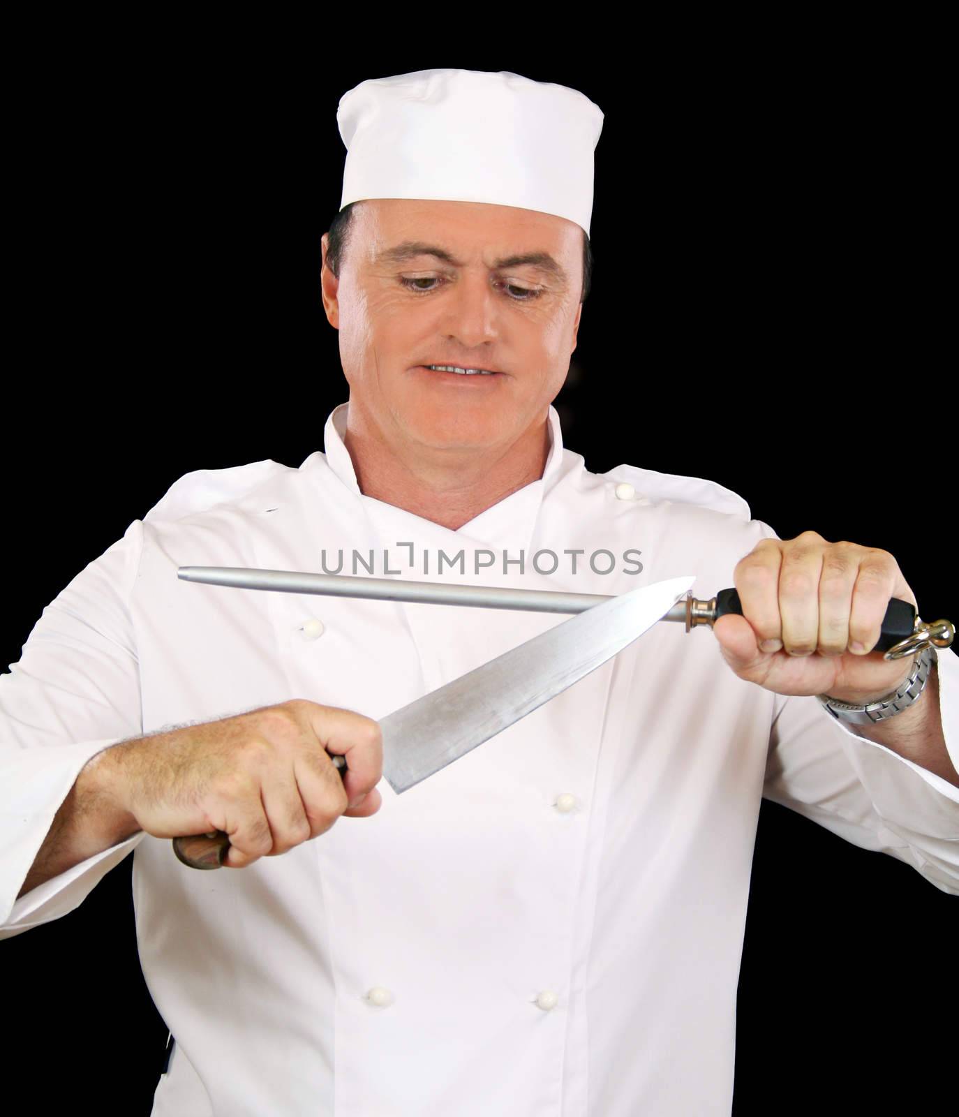 Chef busy sharpening his cooking knife with a steel.