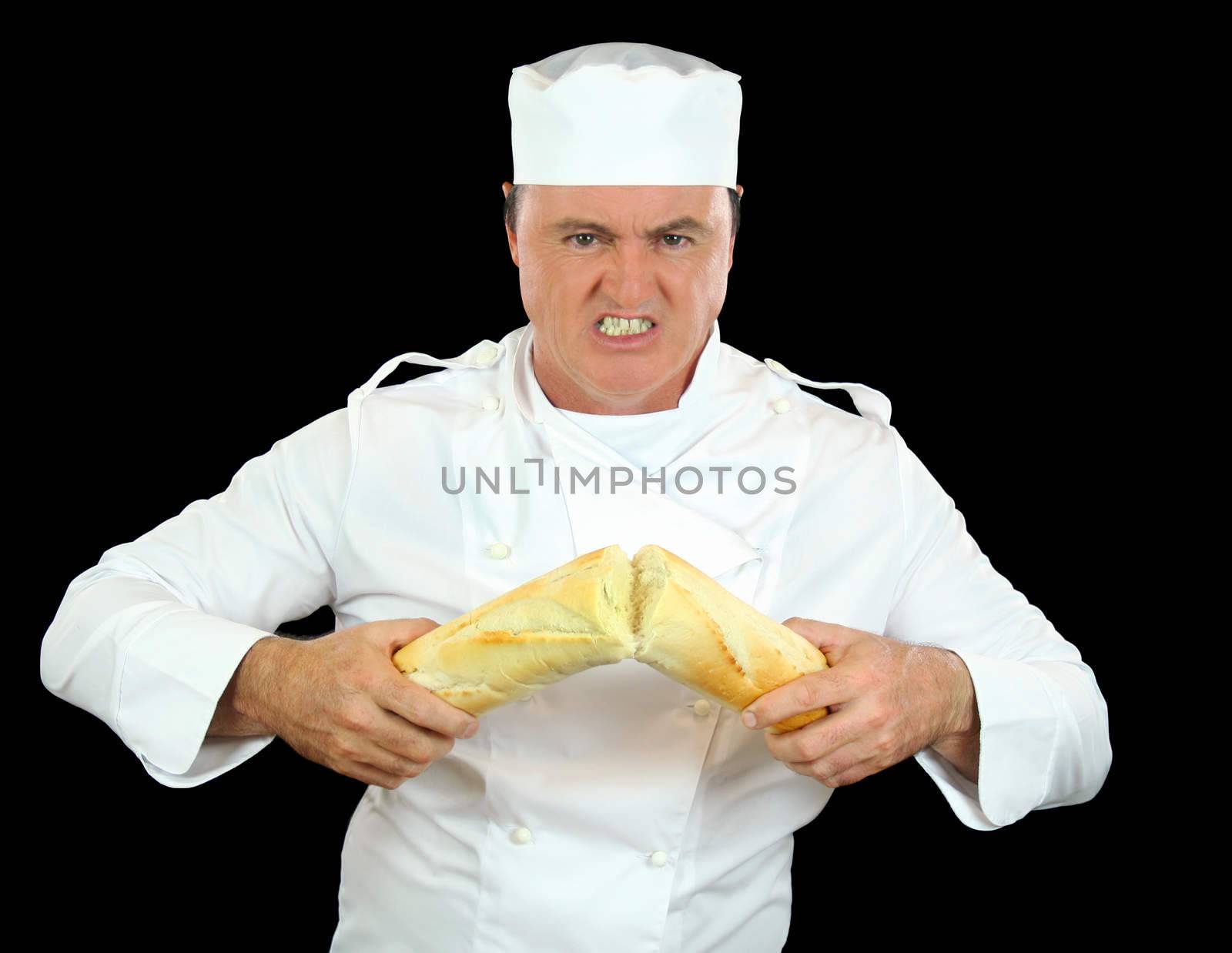 Strongman chef breaks a bread roll with his bare hands.