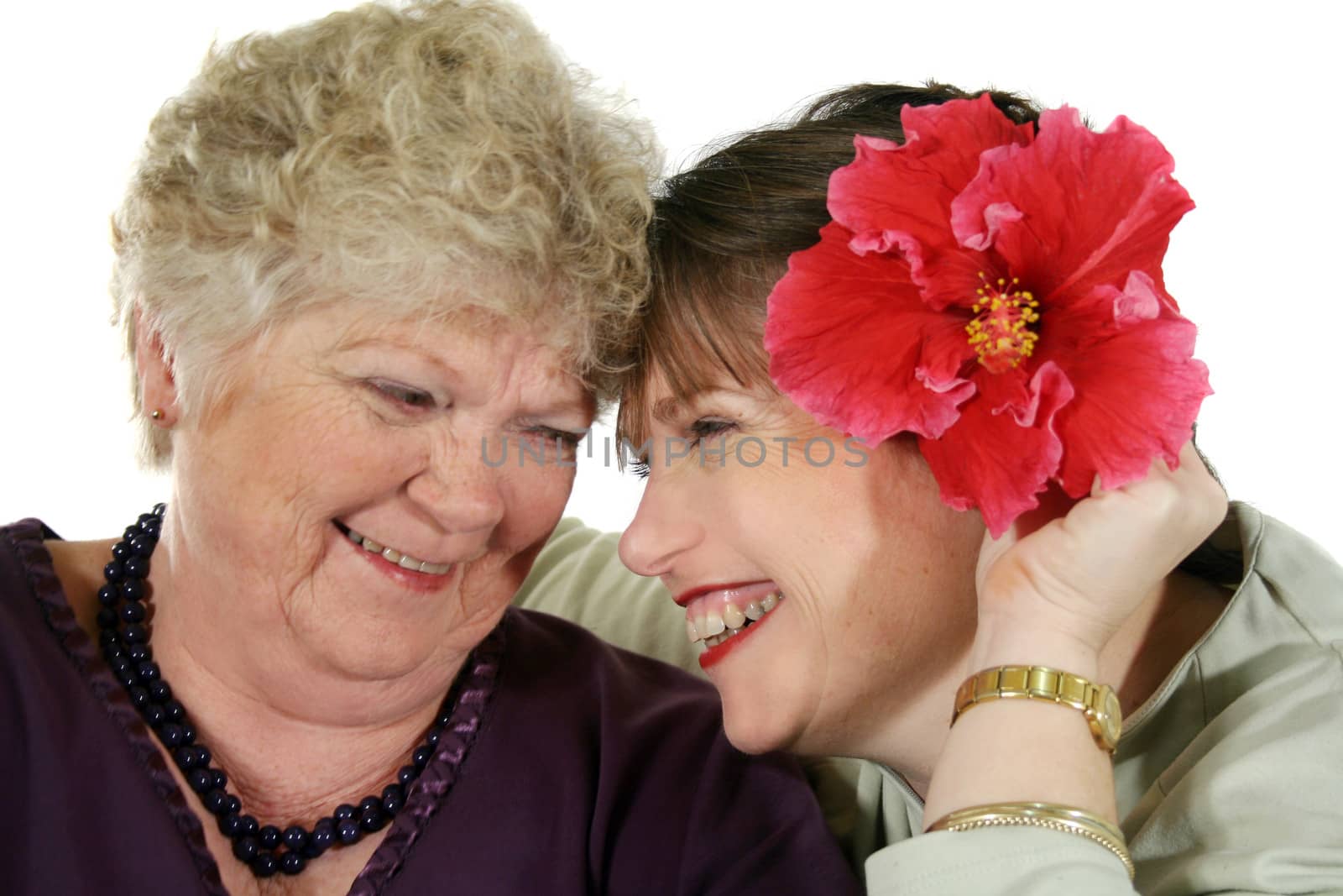 Daughter presenting mother with a hibiscus flower.