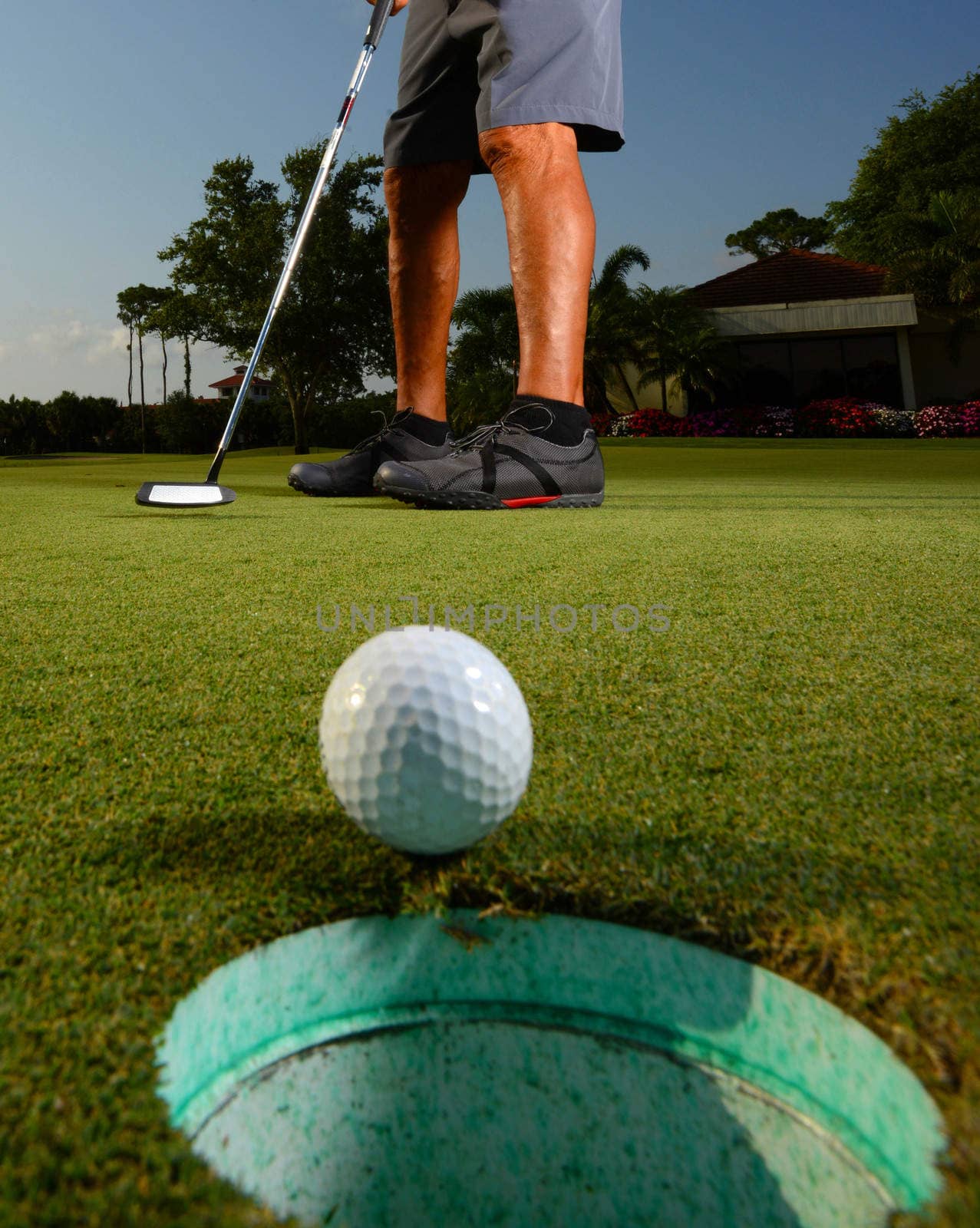 Golfer golfing and close-up of golf ball by ftlaudgirl