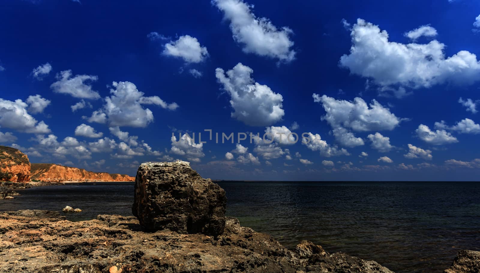 stone on a background of the bay and the cloudy sky