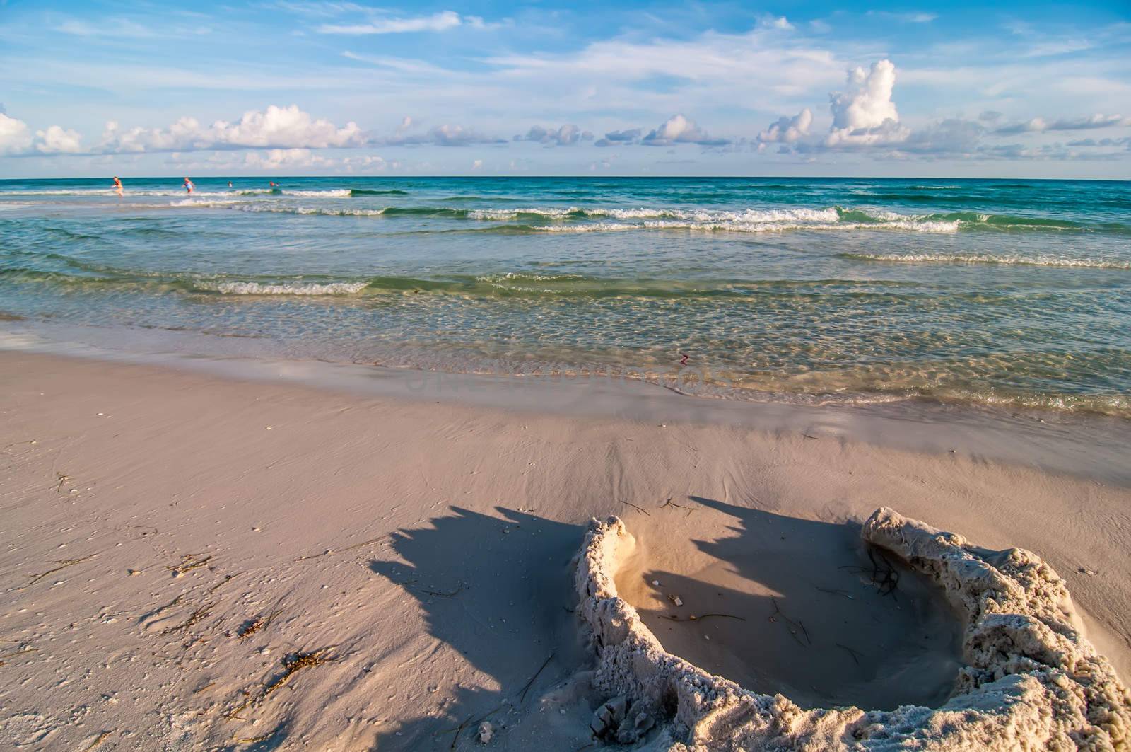 sand structures on beach near ocean waves