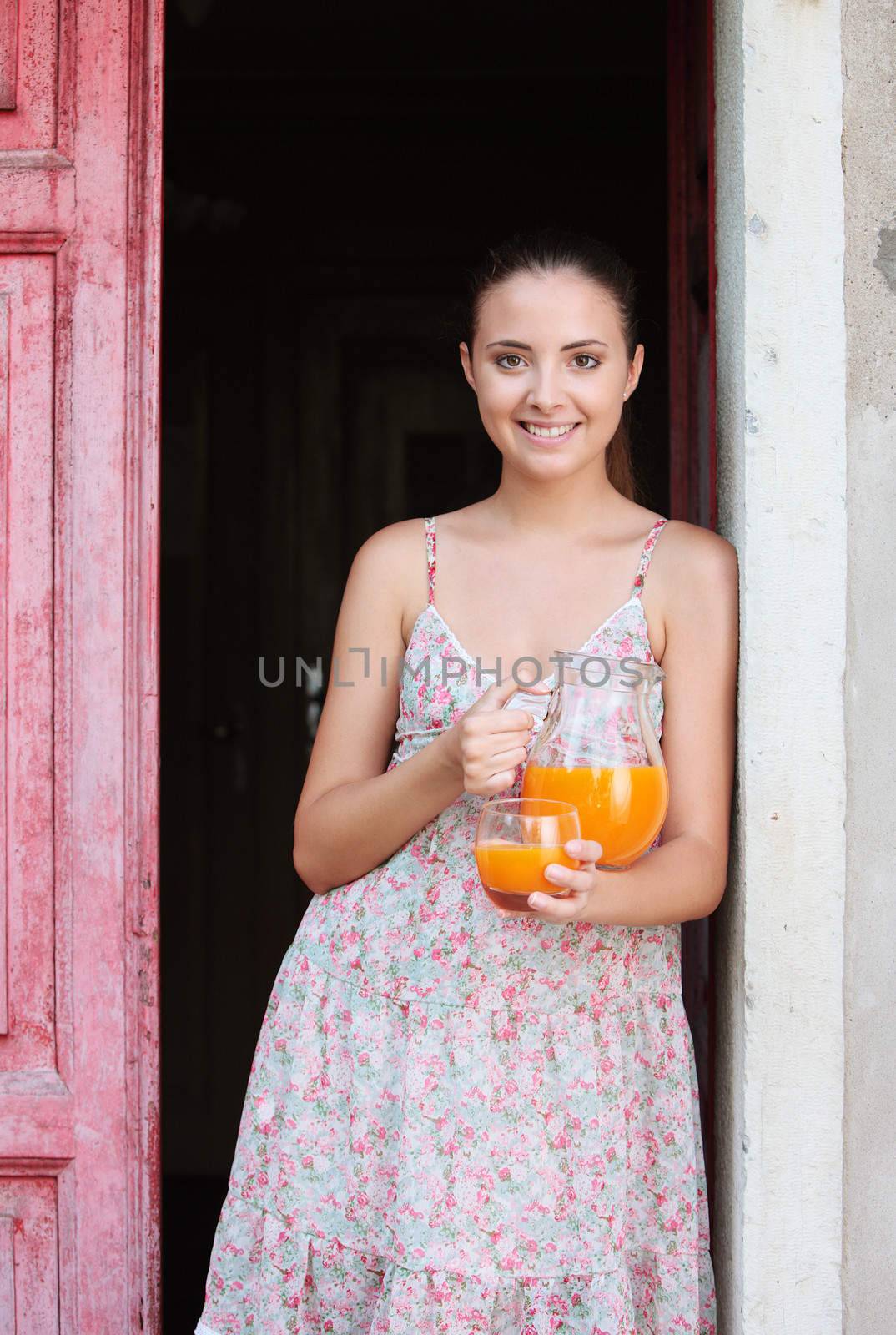 Young smiling woman with orange juice