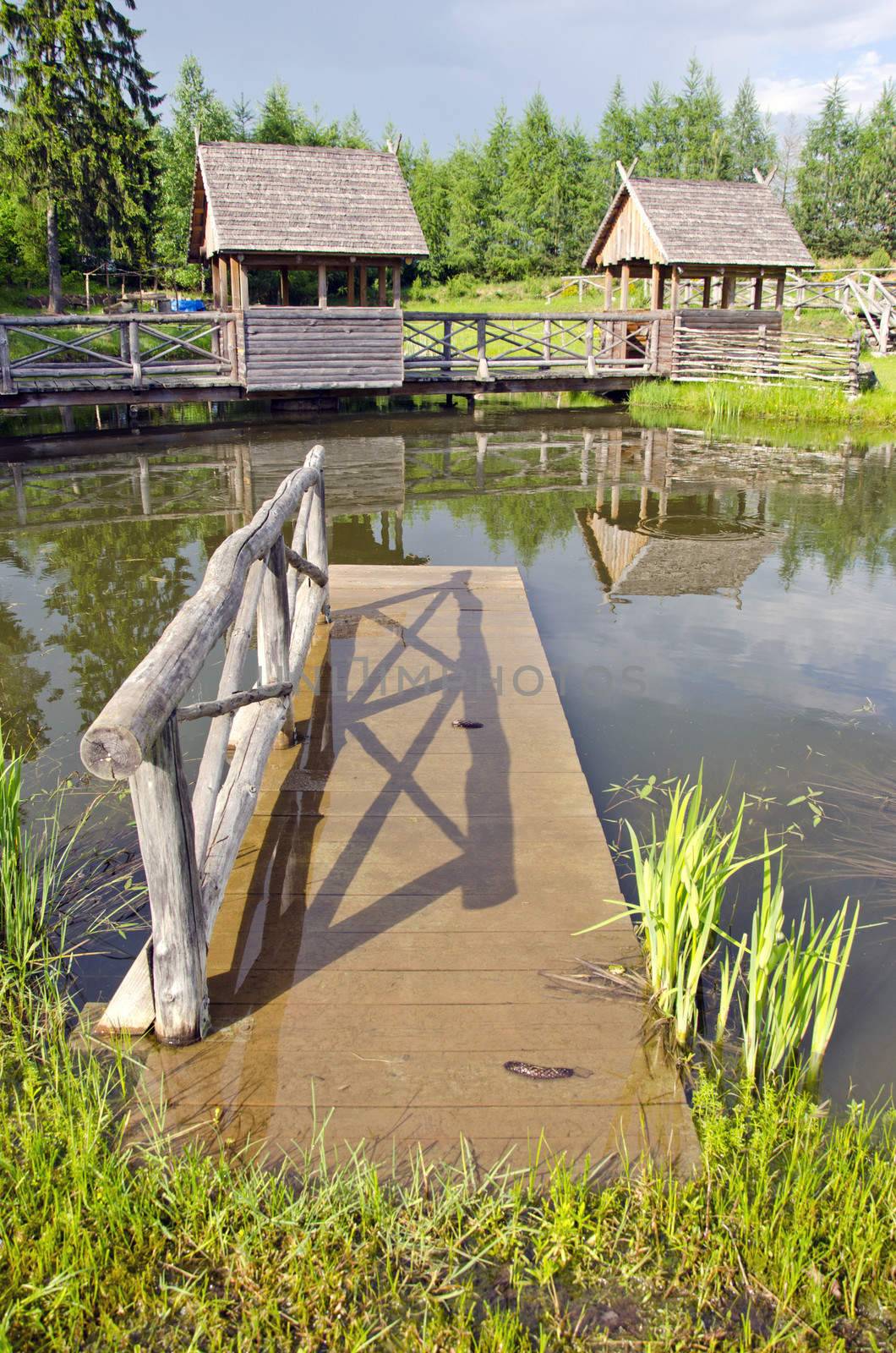 little wooden bridge on summer resort pond