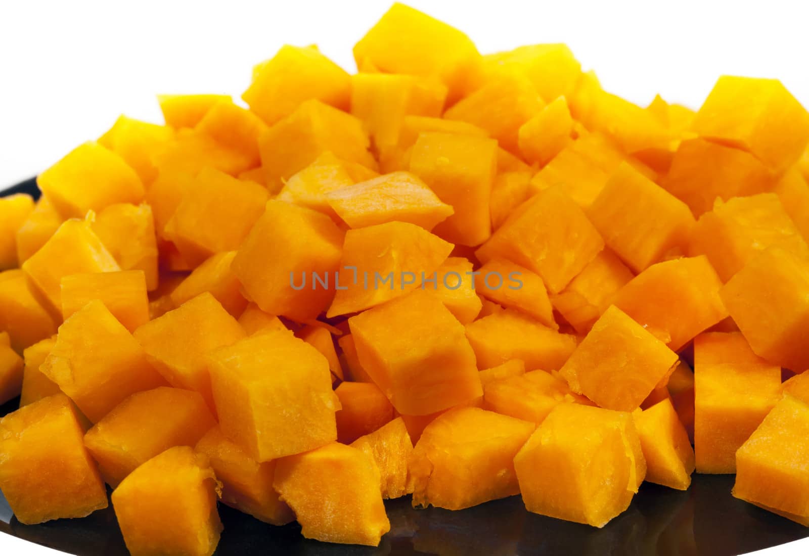 Small hill of orange pumpkin blocks on black plate