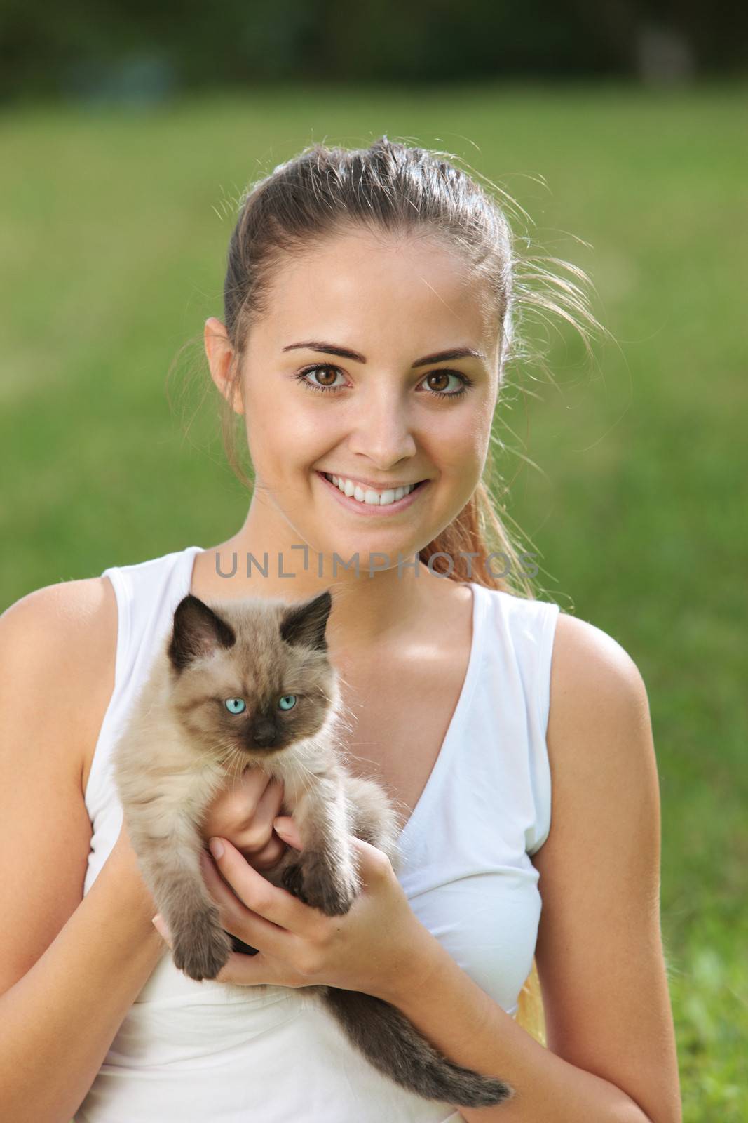 Portrait of smiling young woman with her kitty