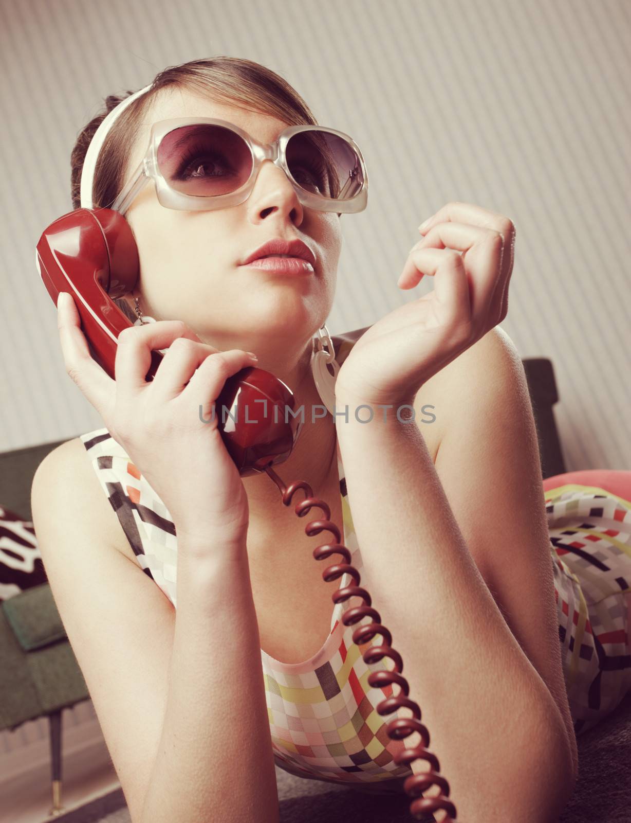 Fashion model talking on the phone at home