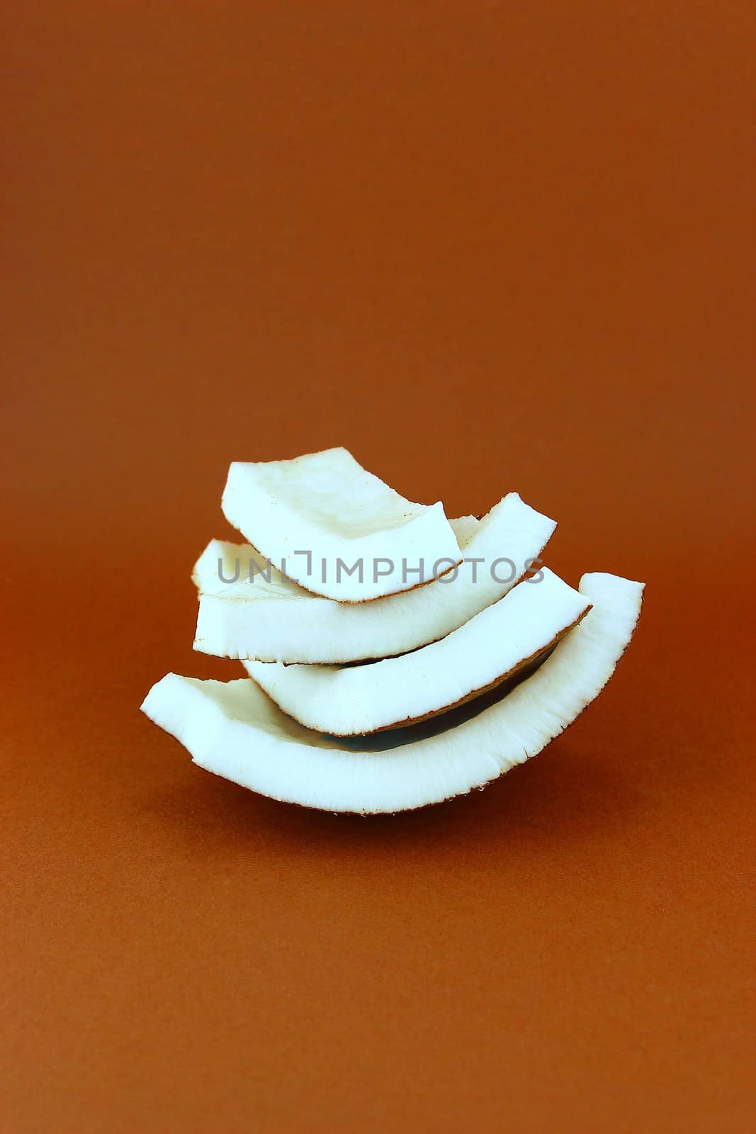 fresh Coconuts with parts on brown background