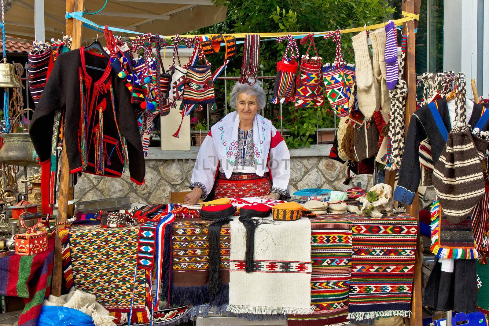 Lady in traditional clothes selling on booth by xbrchx