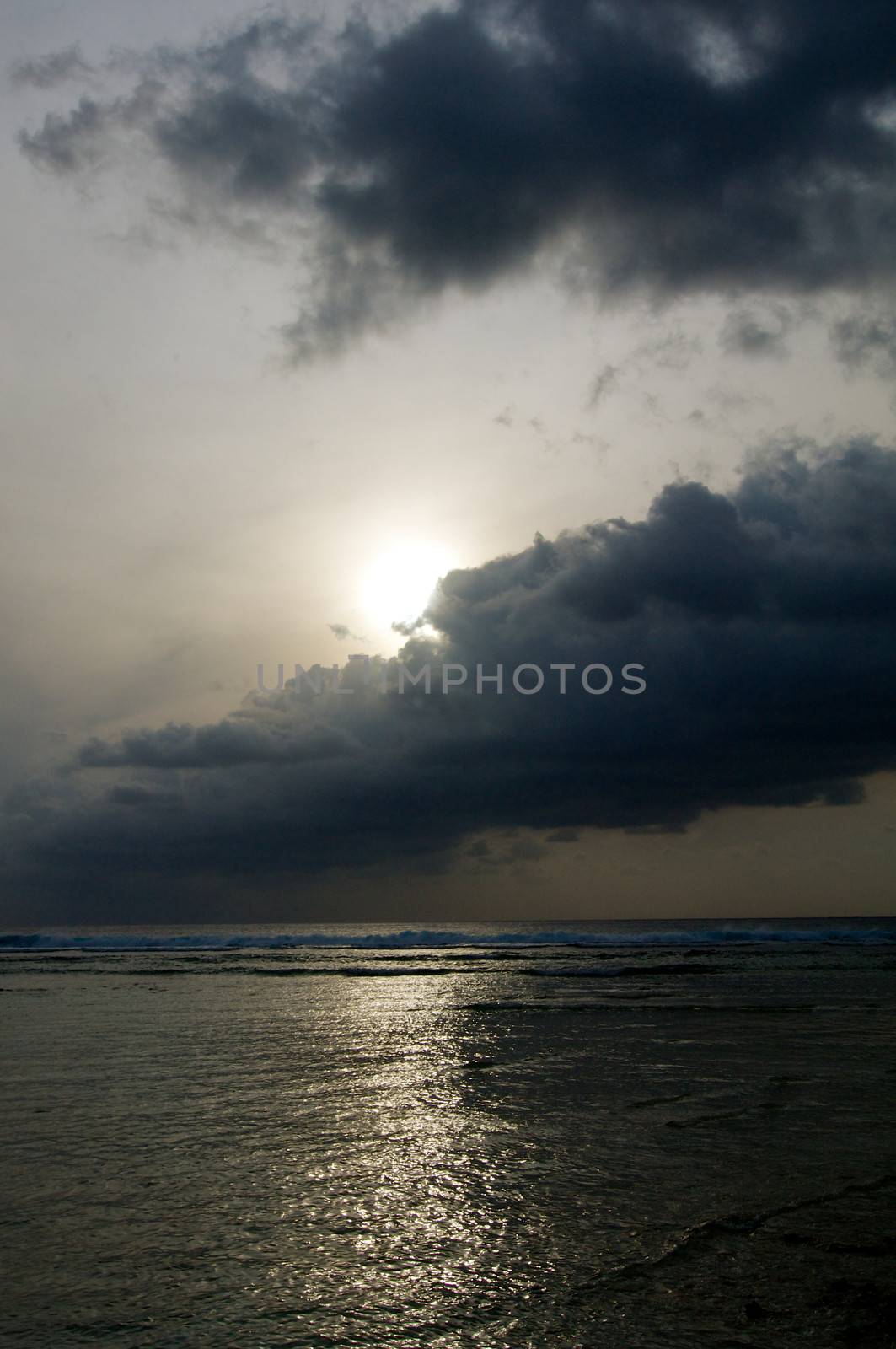 Beginning of Cloudy Sunrise over Ocean Water's Edge and Waves outdoors