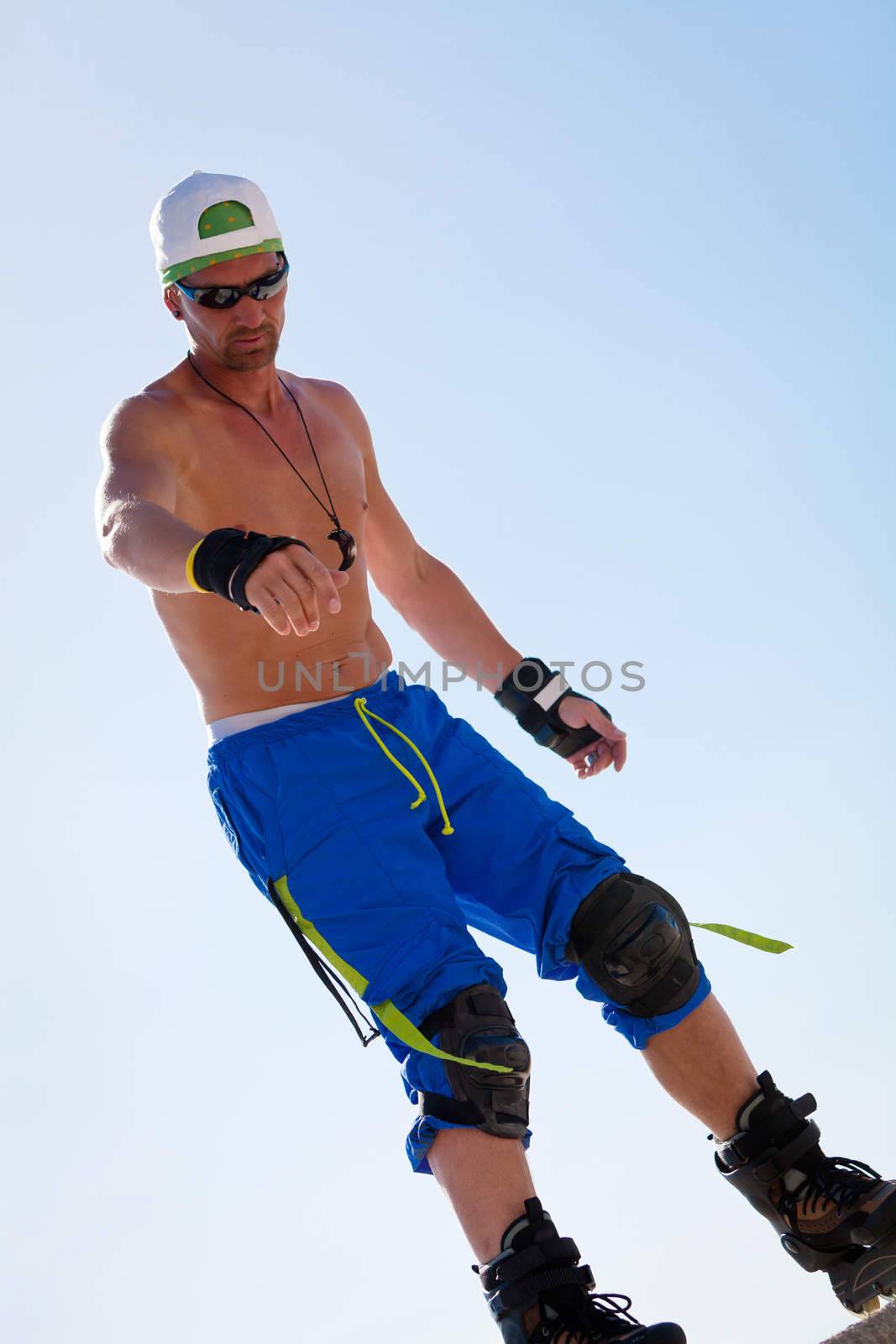 young man with inline skates in summer outdoor rollerblades skater