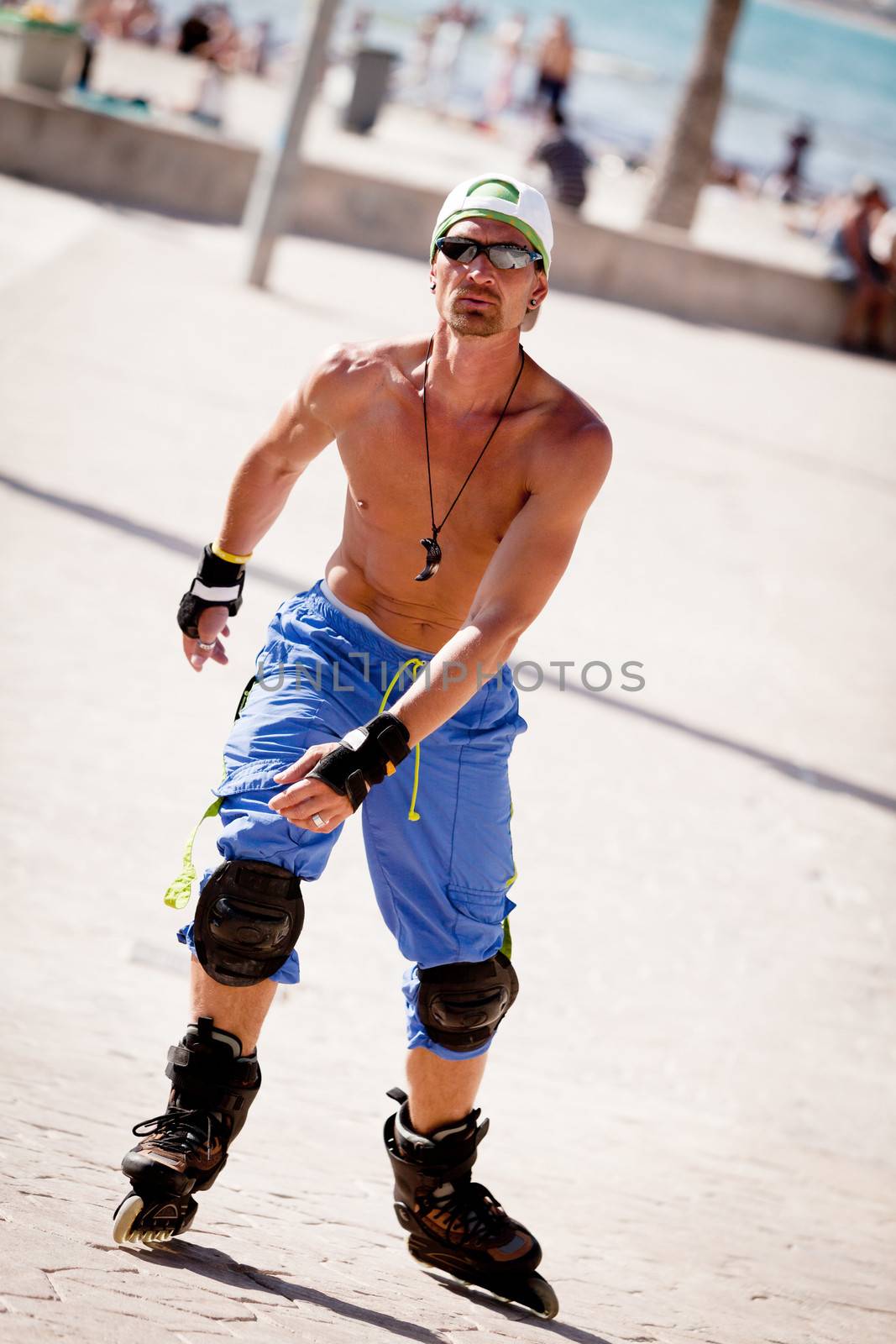 young man with inline skates in summer outdoor rollerblades skater