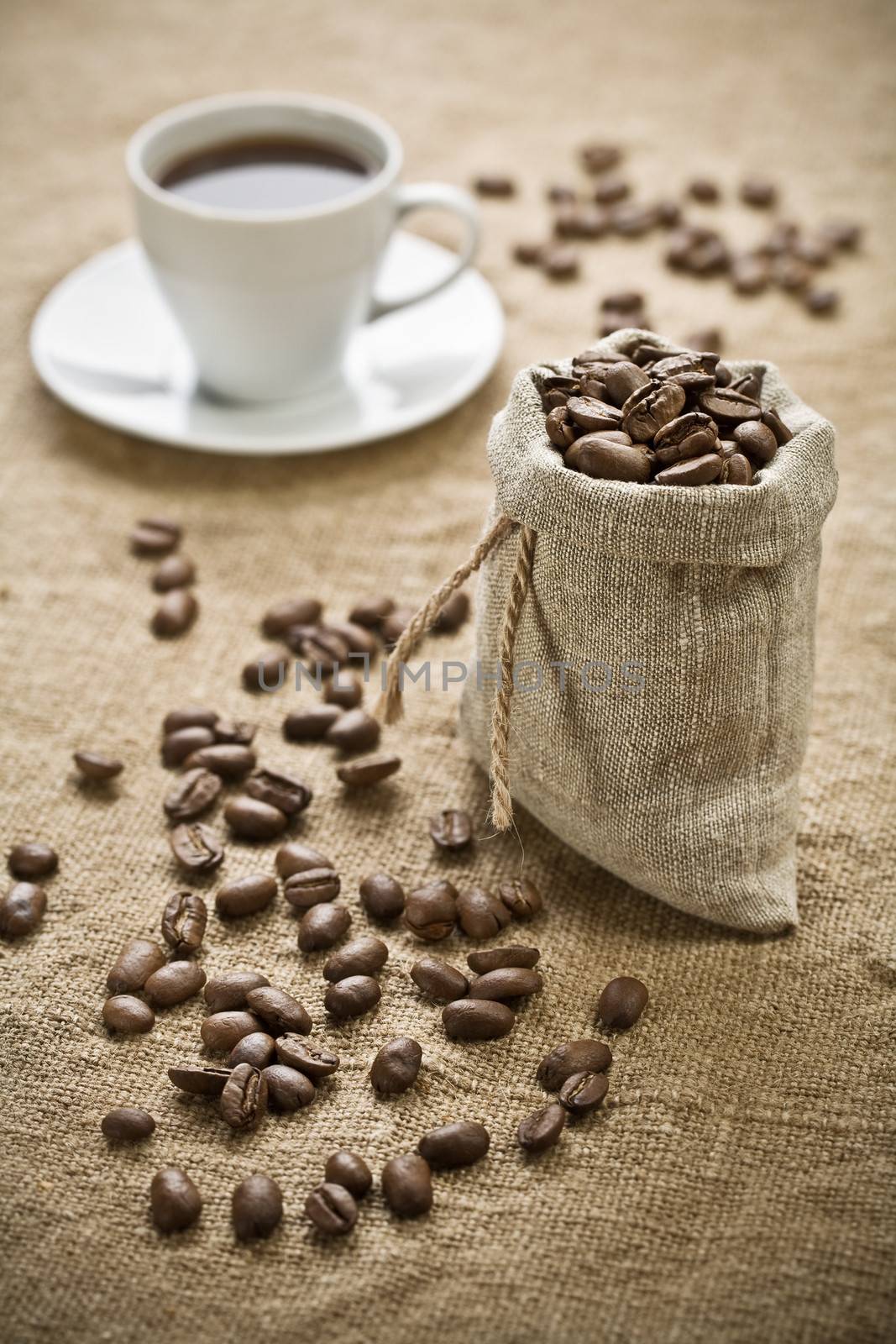 coffee beans and cup of coffee on sacking 