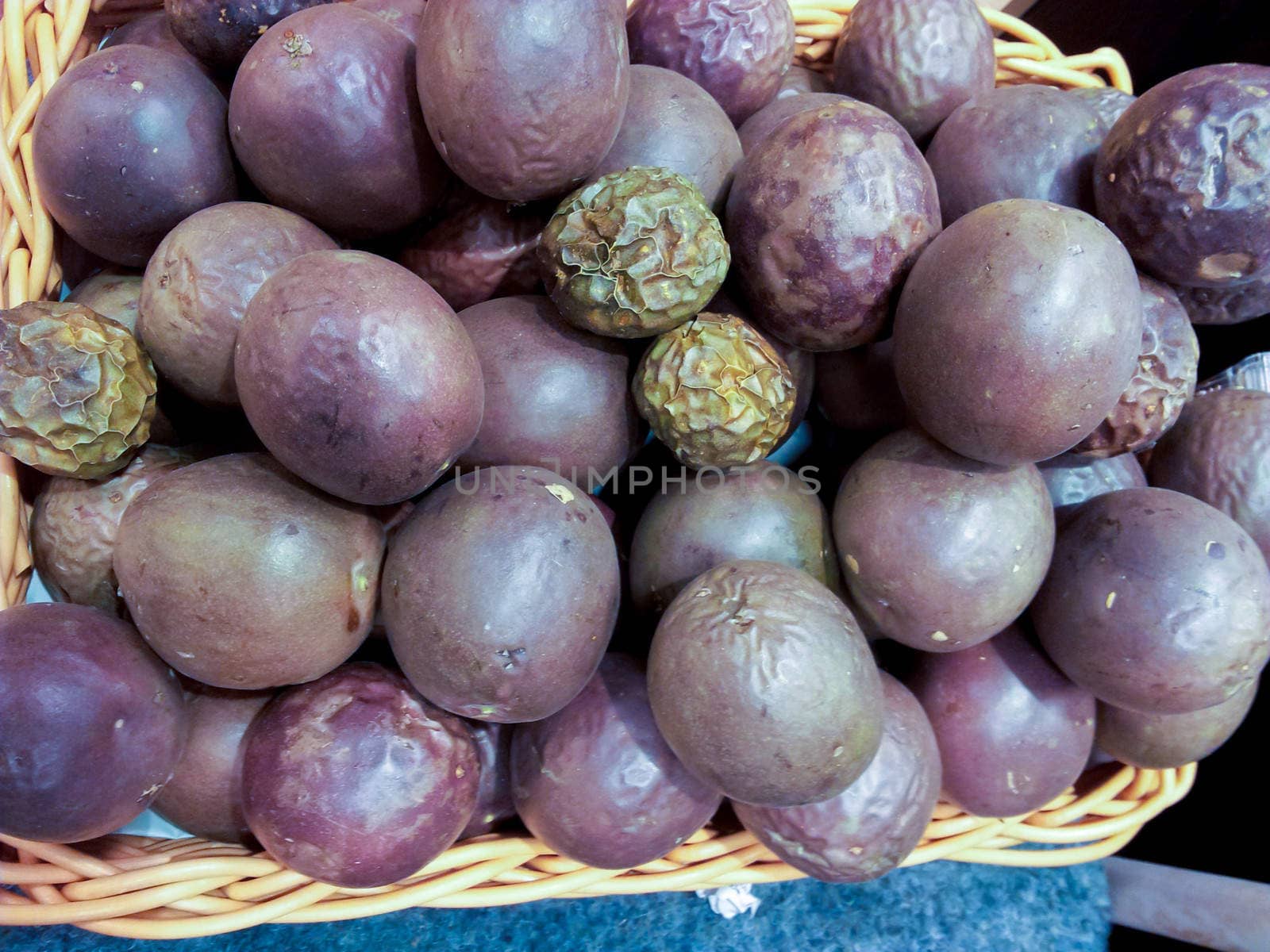 Group of whole passion fruit in basket