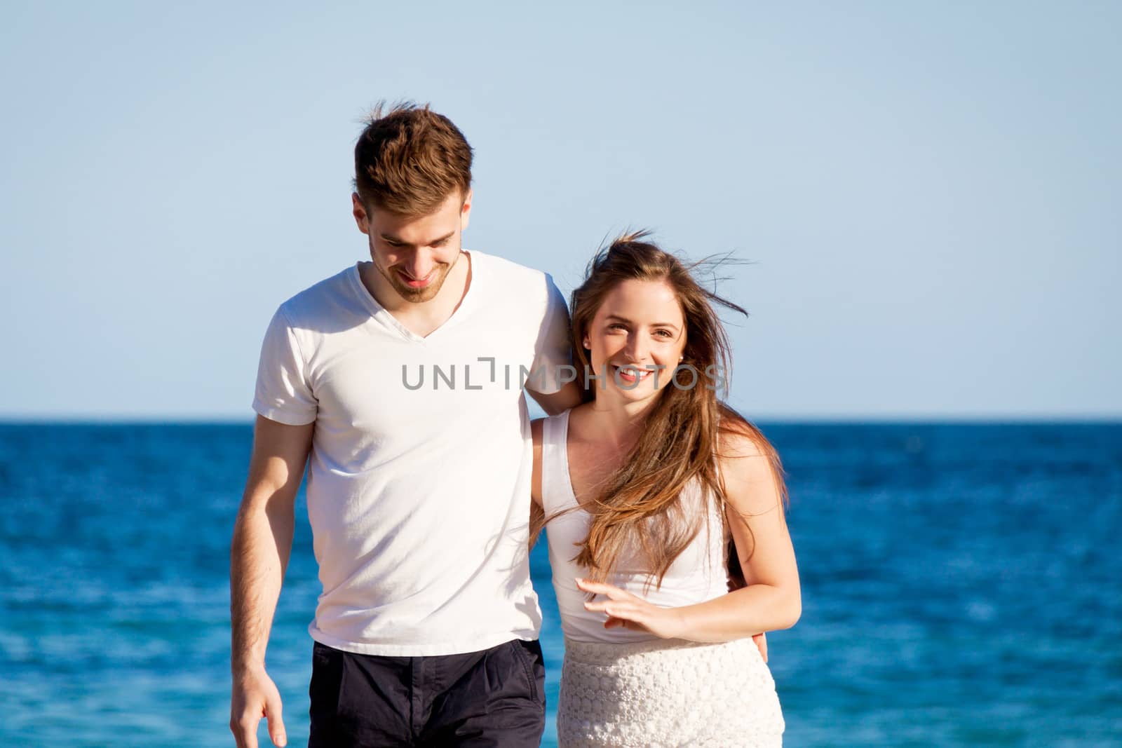 happy young couple on the beach carefree summertime holiday