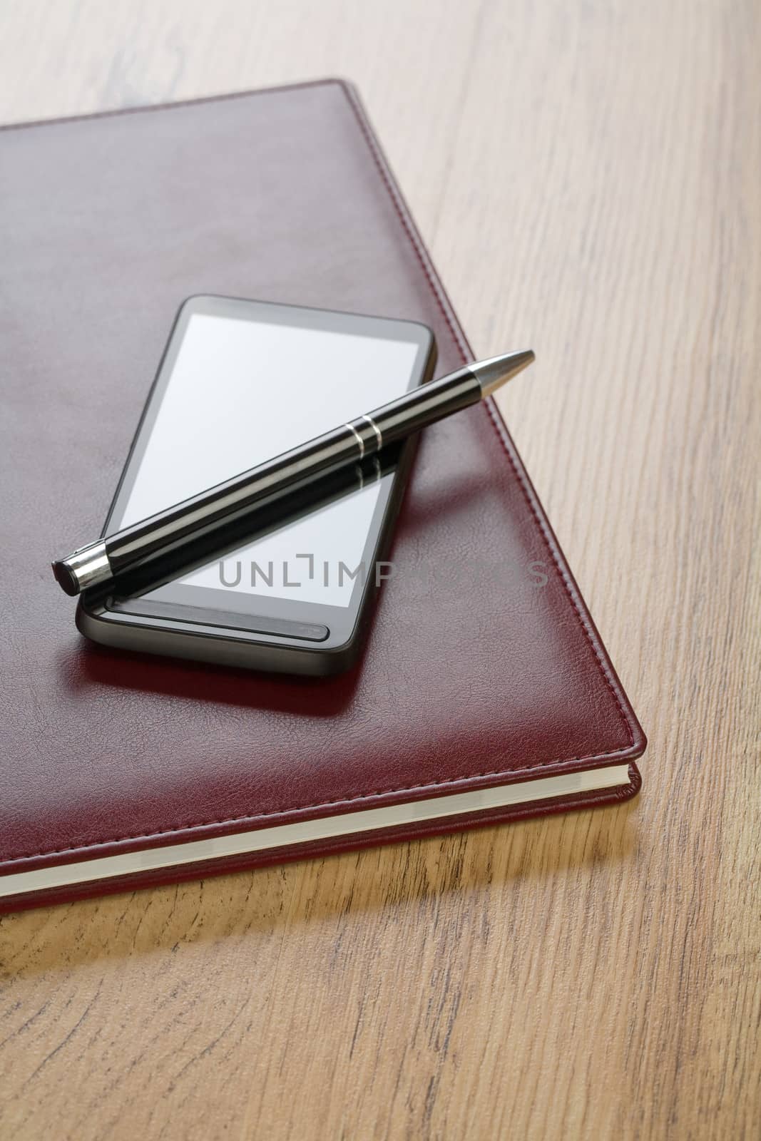notebook with pen and mobile phone