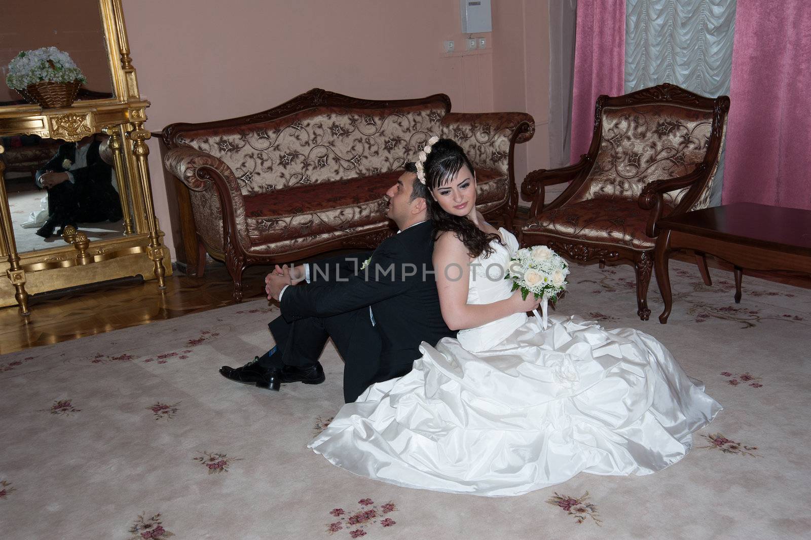 bride and groom in the living room sitting on the floor