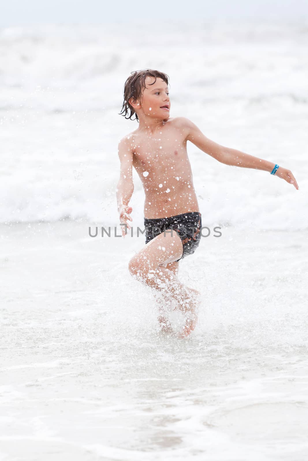 young little boy in water summer holiday having fun sea ocean 