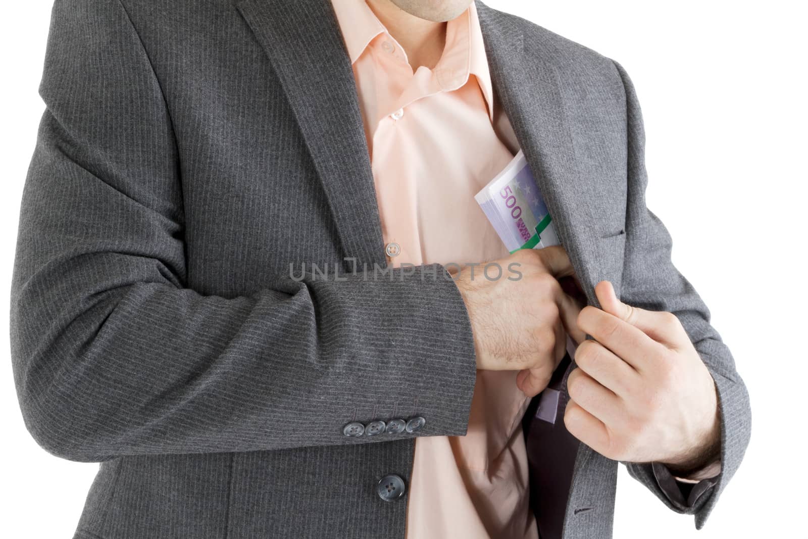 man puts a stack of banknotes in a pocket on a white background