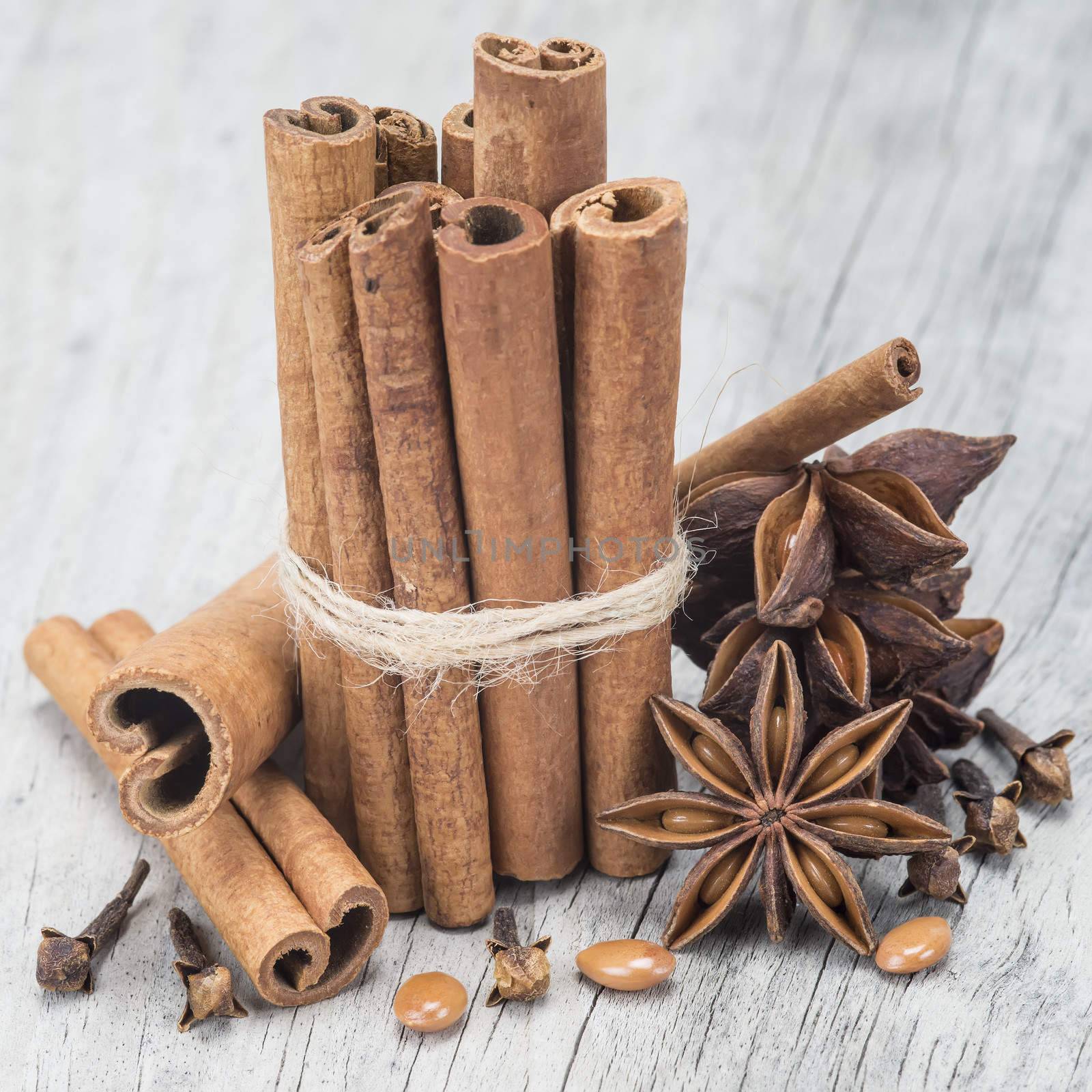Cinnamon sticks and star anise on a wooden background