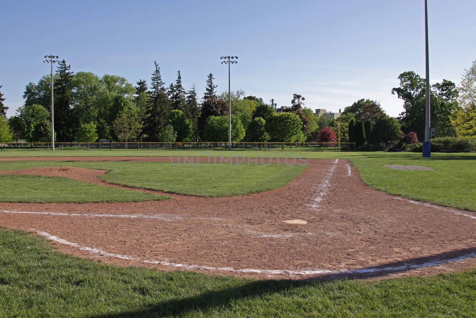 A shot of an unoccupied baseball field at dusk.
