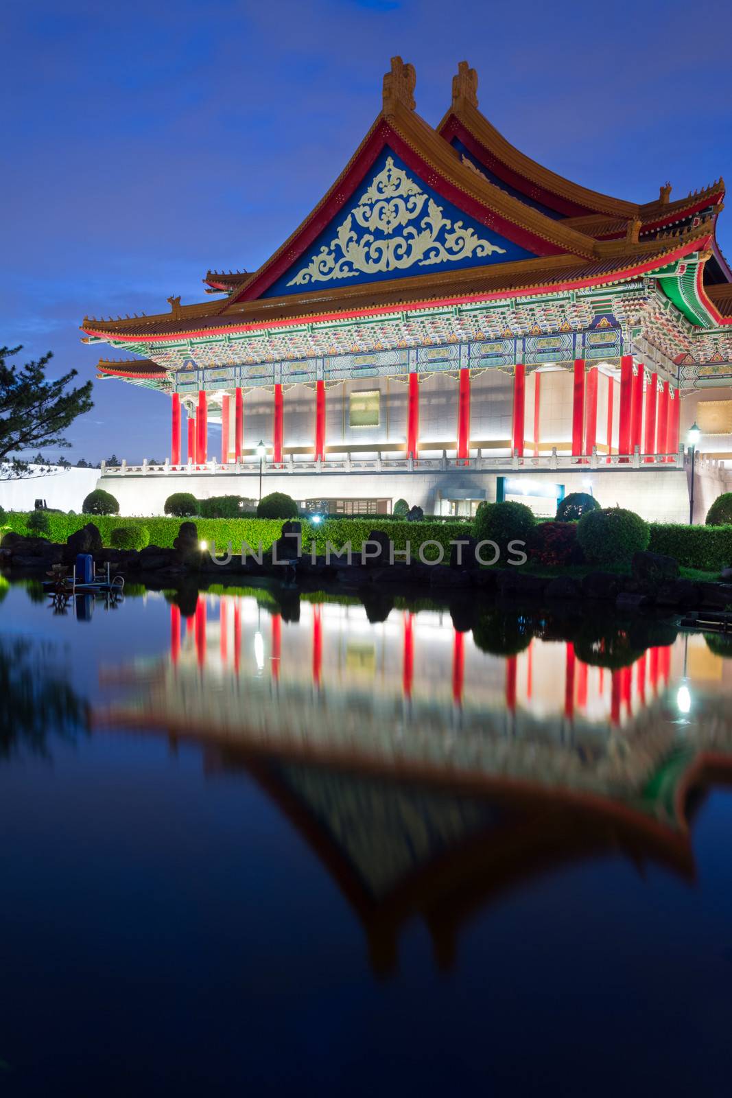 Chinese style building, National Concert Hall, with reflection on water in Taipei, Taiwan, Asia in the night.