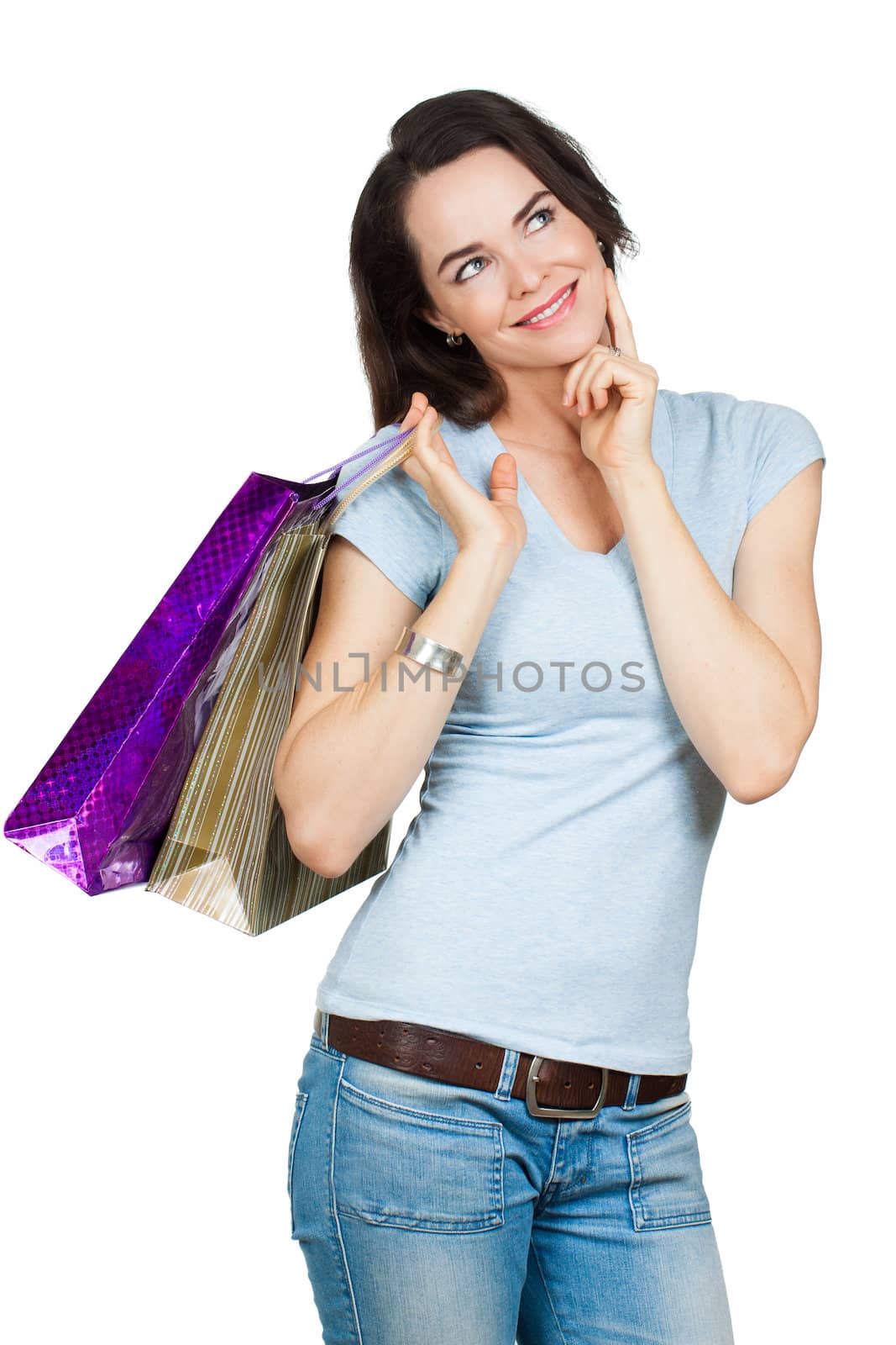 A beautiful contemplative woman holding shopping bags and looking at copy-space. Isolated on white.