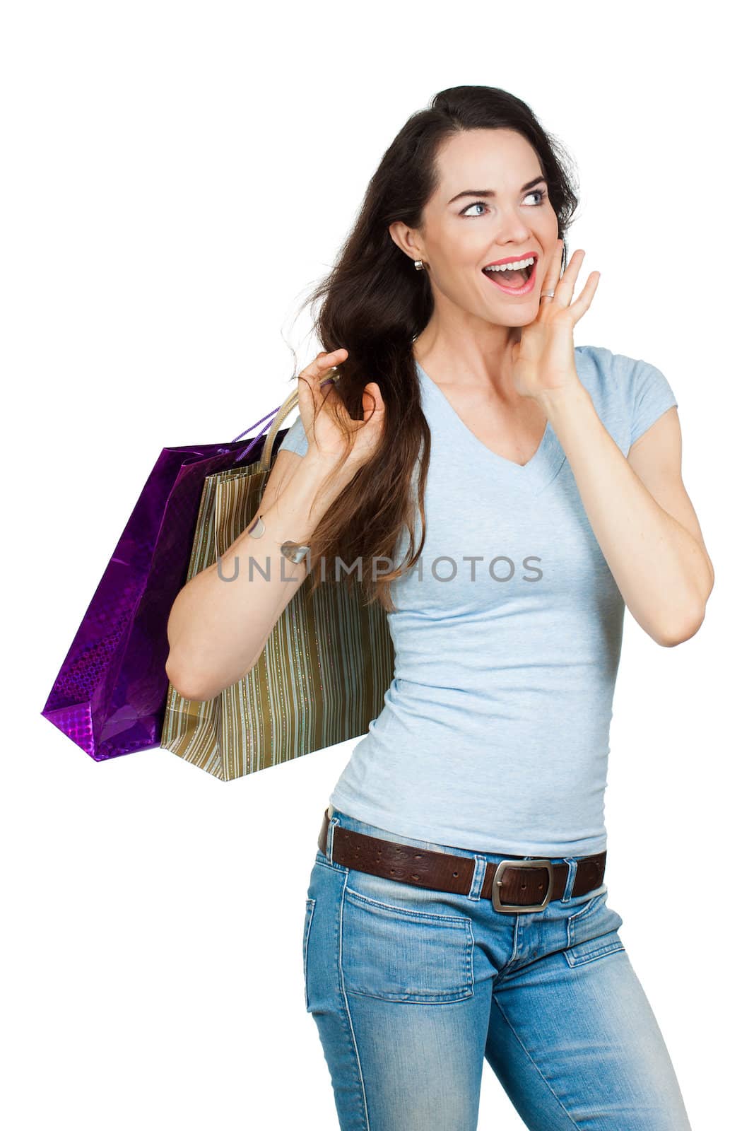 A happy surprised woman with shopping bags. Isolated on white.