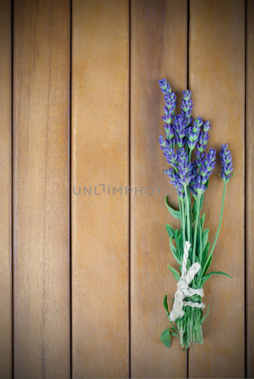 a bunch of lavender flowers on a wooden background by motorolka