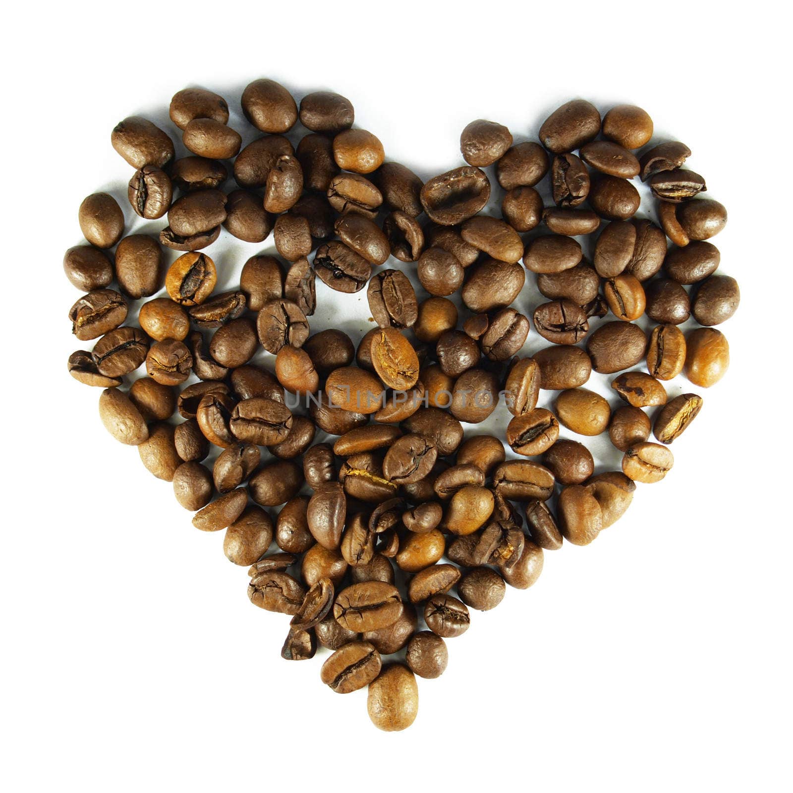 Coffee grains laid out in the form of heart on the isolated white background