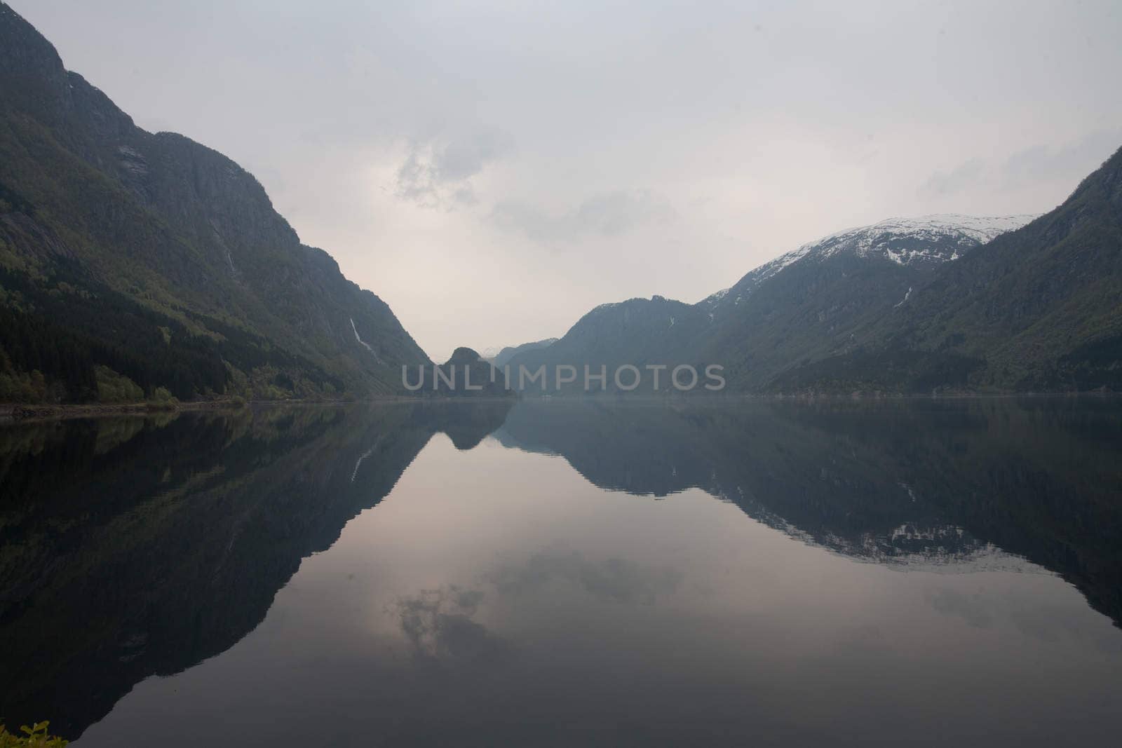 The picture shows somewhere in Norway with mountains and fjords.