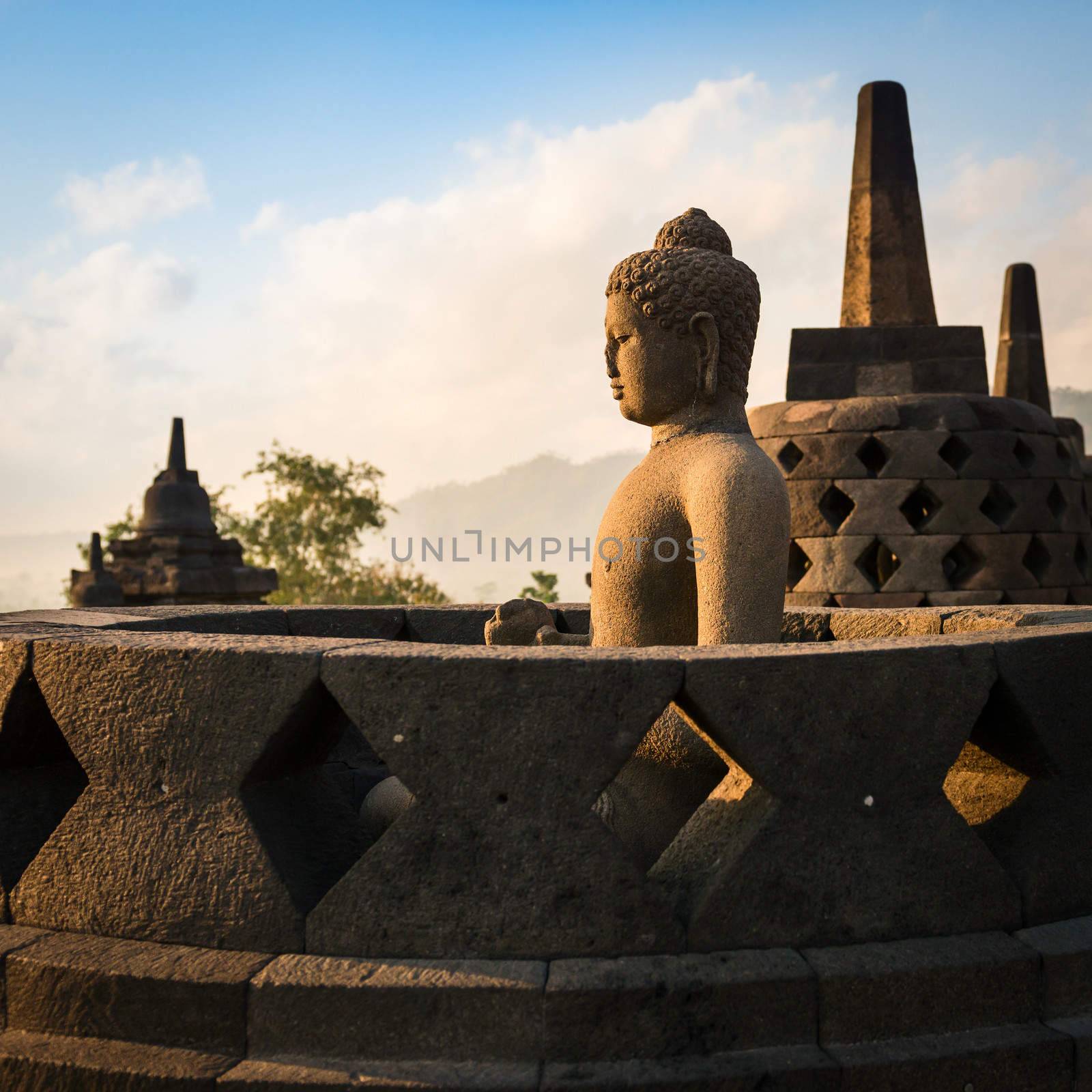 Buddha in Borobudur Temple at sunrise. Indonesia.  by iryna_rasko