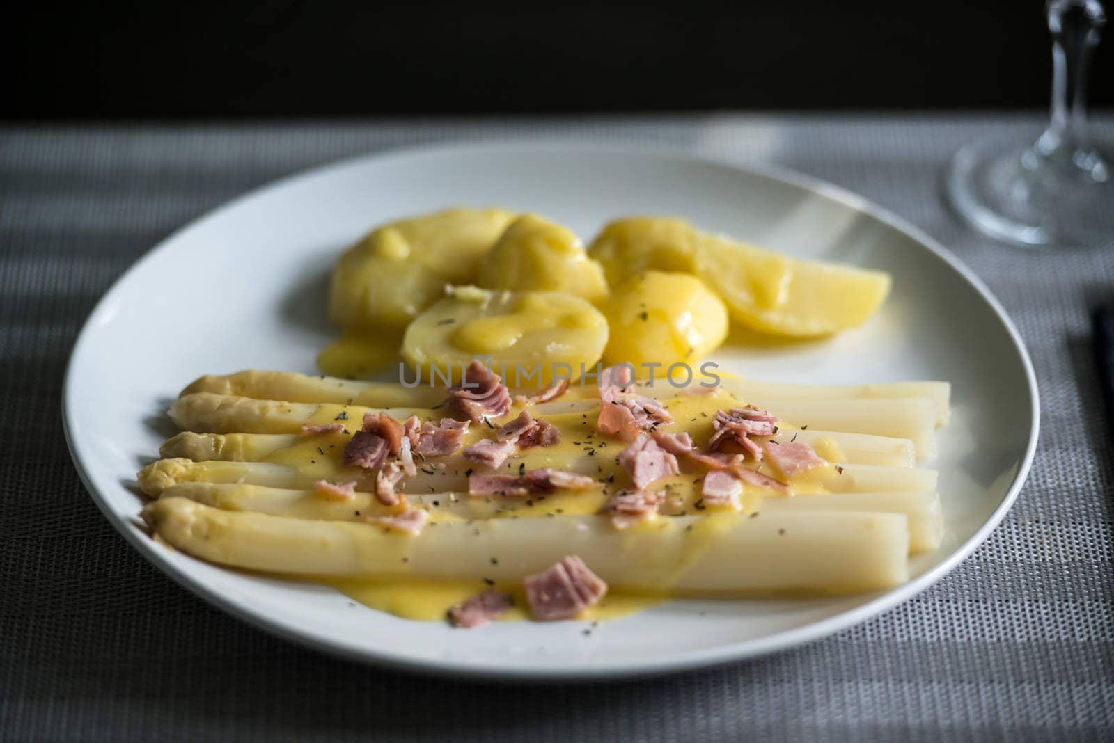 fresh white asparagus with potatoes, sauce hollandaise and ham