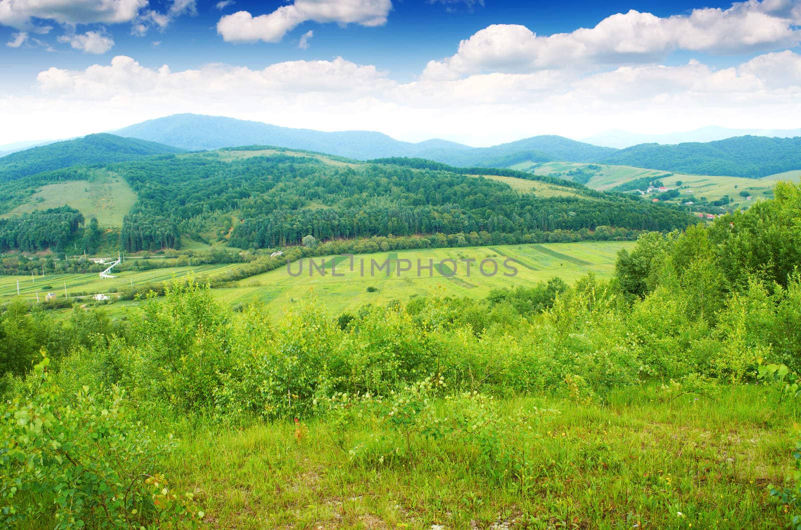 The village is in the distance in the European mountains