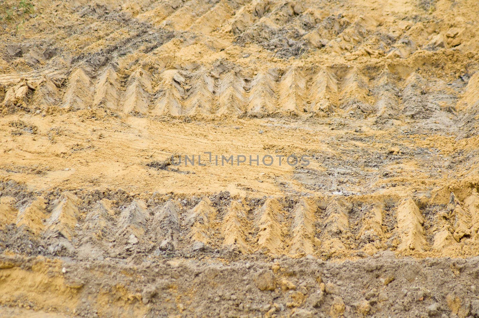 caterpillar wheel on soil background