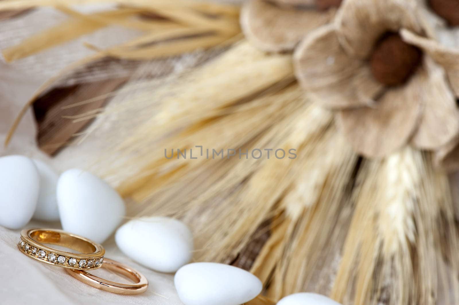 a  candy, wedding rings and flowers