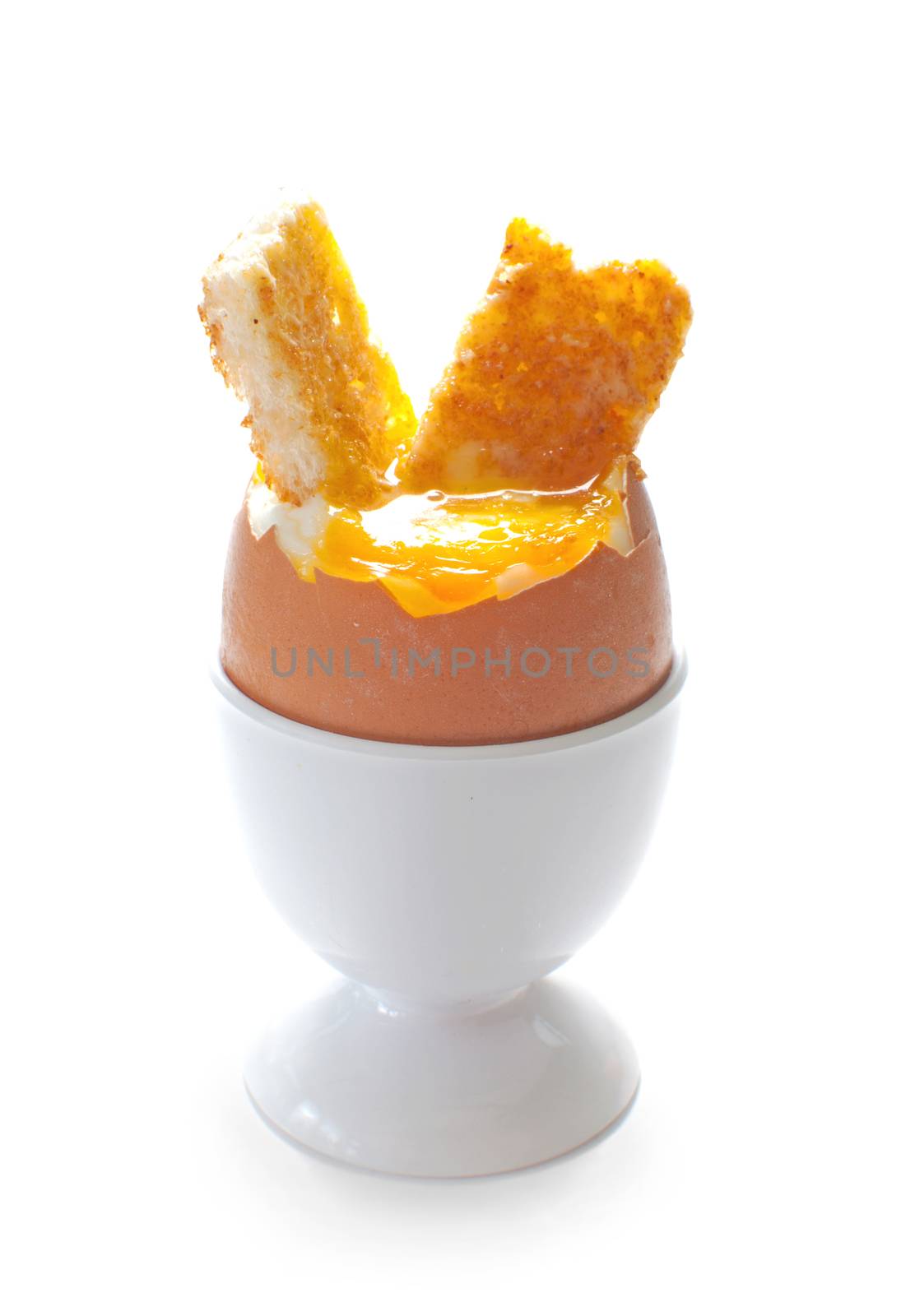 Boiled egg in a cup holder with buttered toasted soldiers 