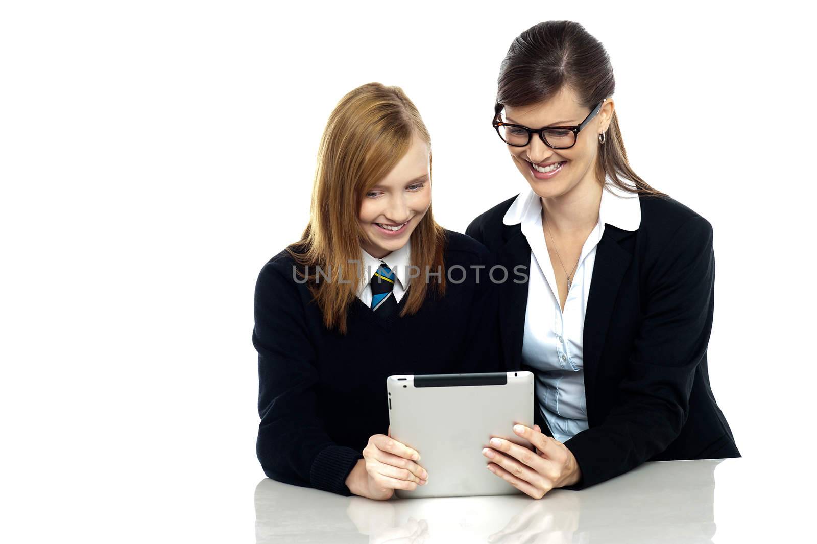 Student with teacher exploring a tablet device
