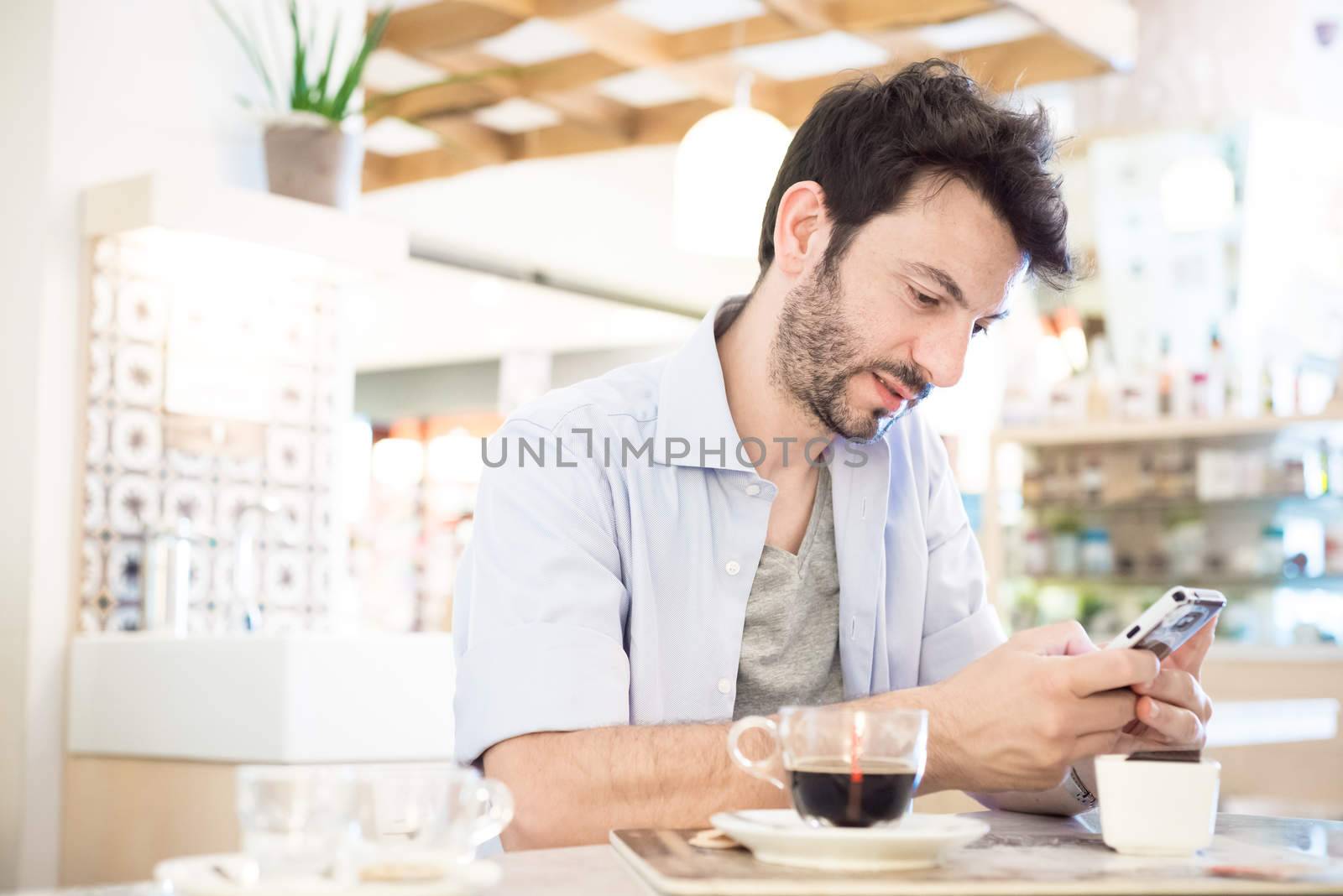 man at the bar on the phone in the morning